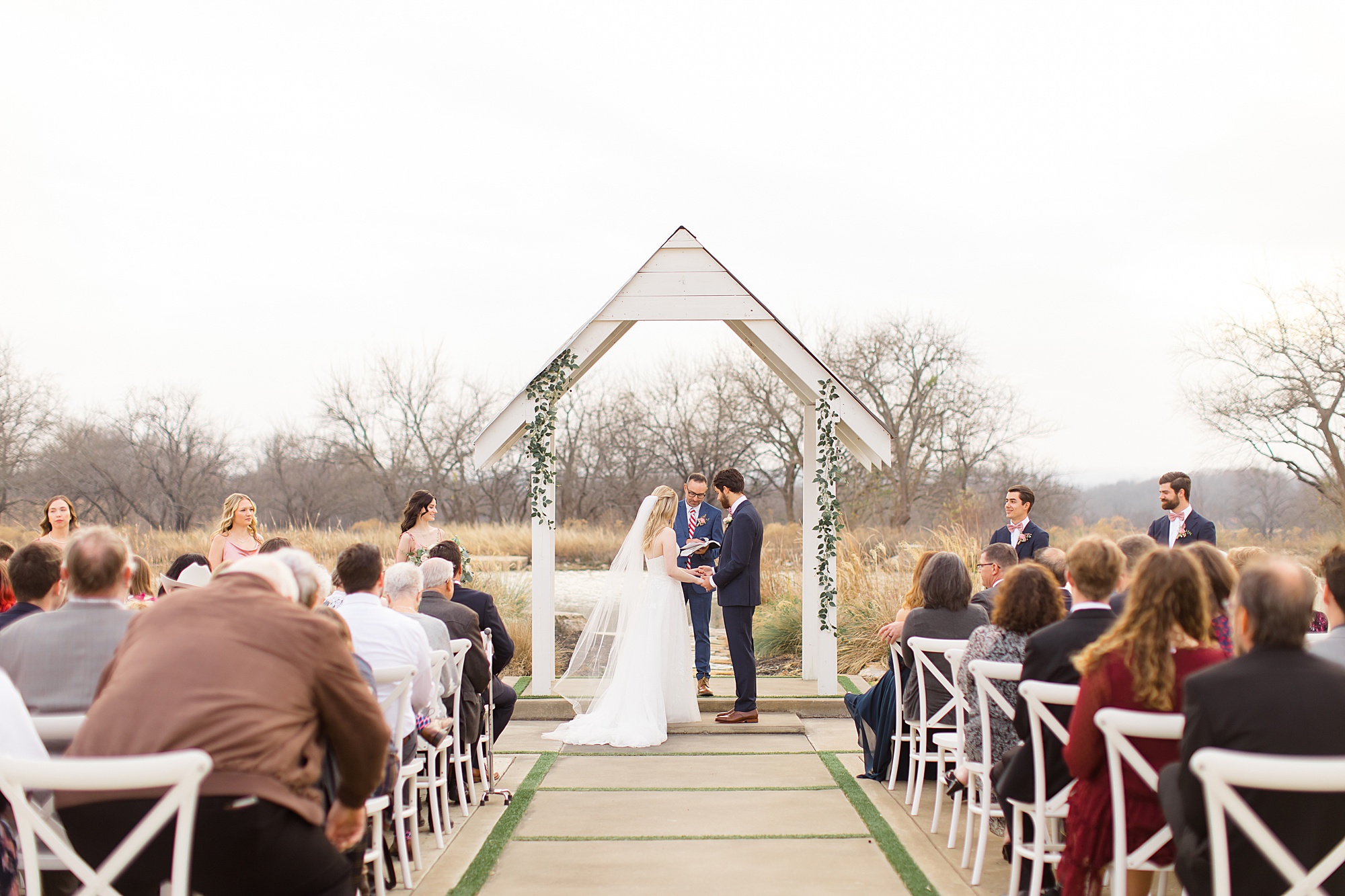 couple exchanges vows during outdoor wedding ceremony in the winter