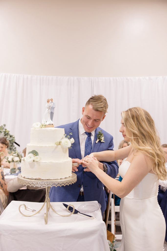 couple cuts wedding cake during Rosewell NM wedding reception