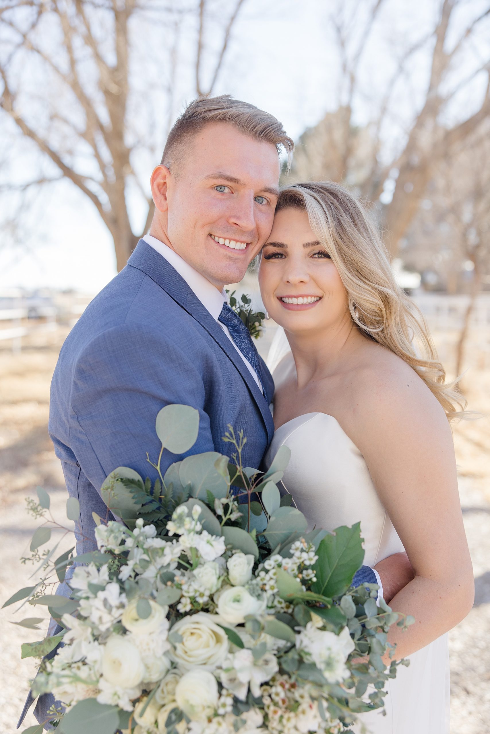 newlyweds lean heads together during New Mexico wedding day