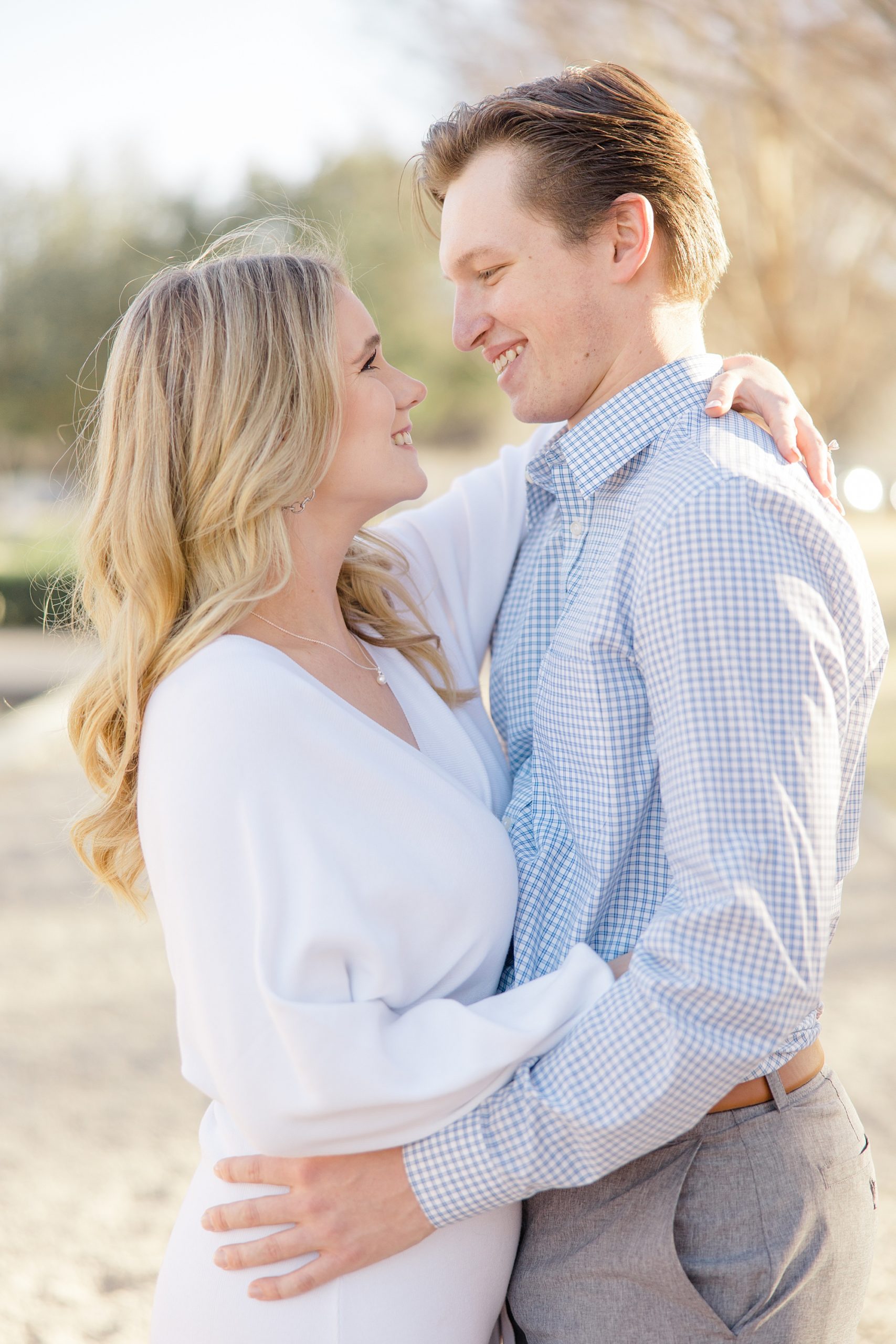 bride and groom hug in gardens during TX engagement session