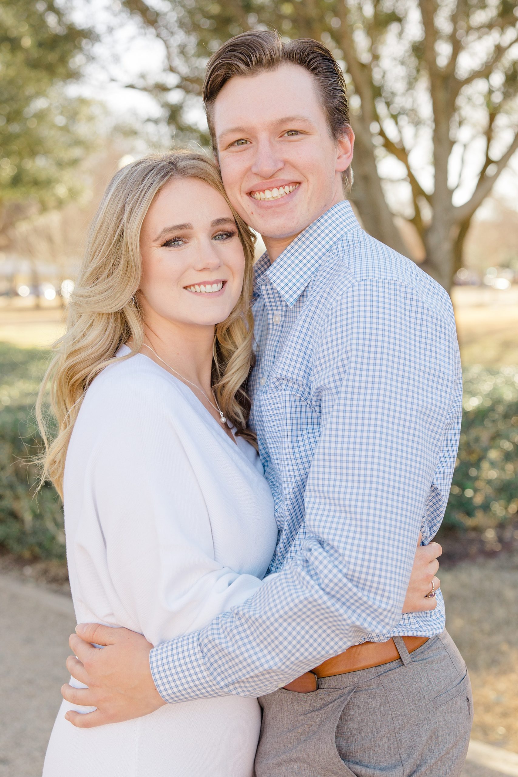 bride and groom hug during Texas engagement session