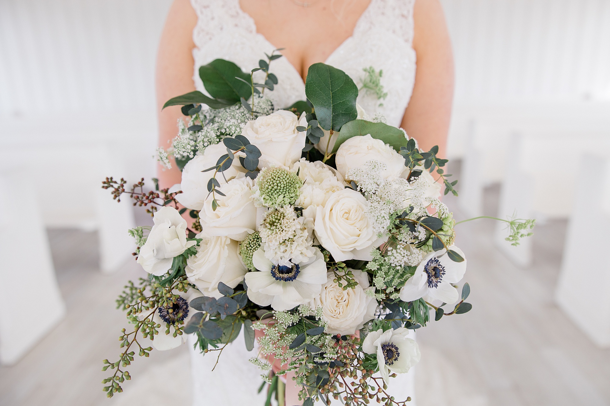 bride holds bouquet of white flowers during The Grand Ivory bridal session