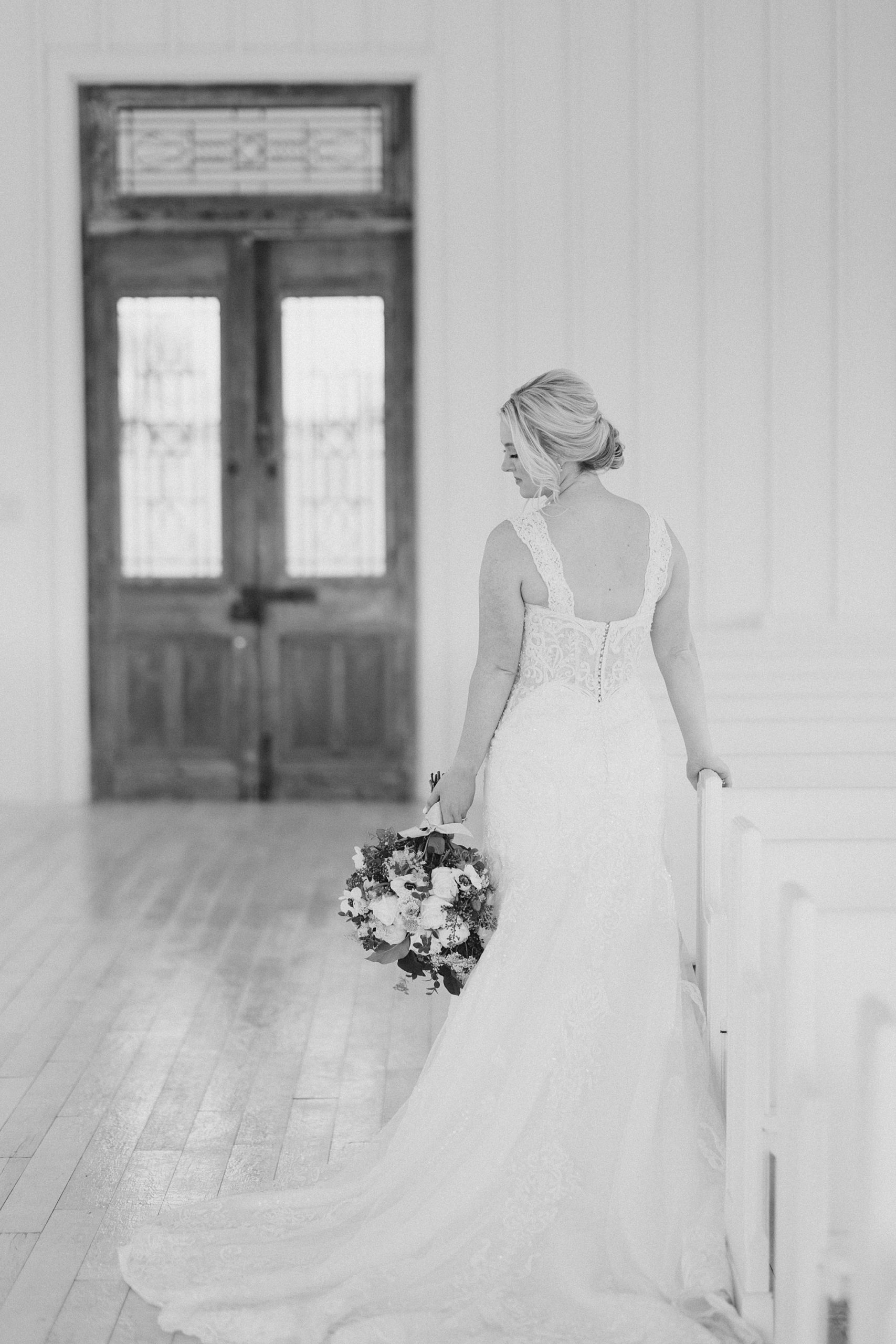 bride walks with bouquet hanging by her side at The Grand Ivory