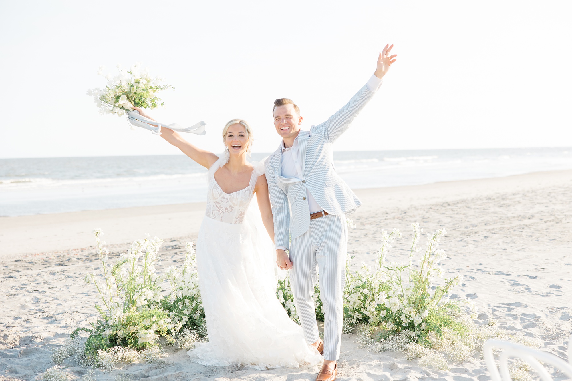 bride and groom cheer during wedding ceremony at Folly Beach