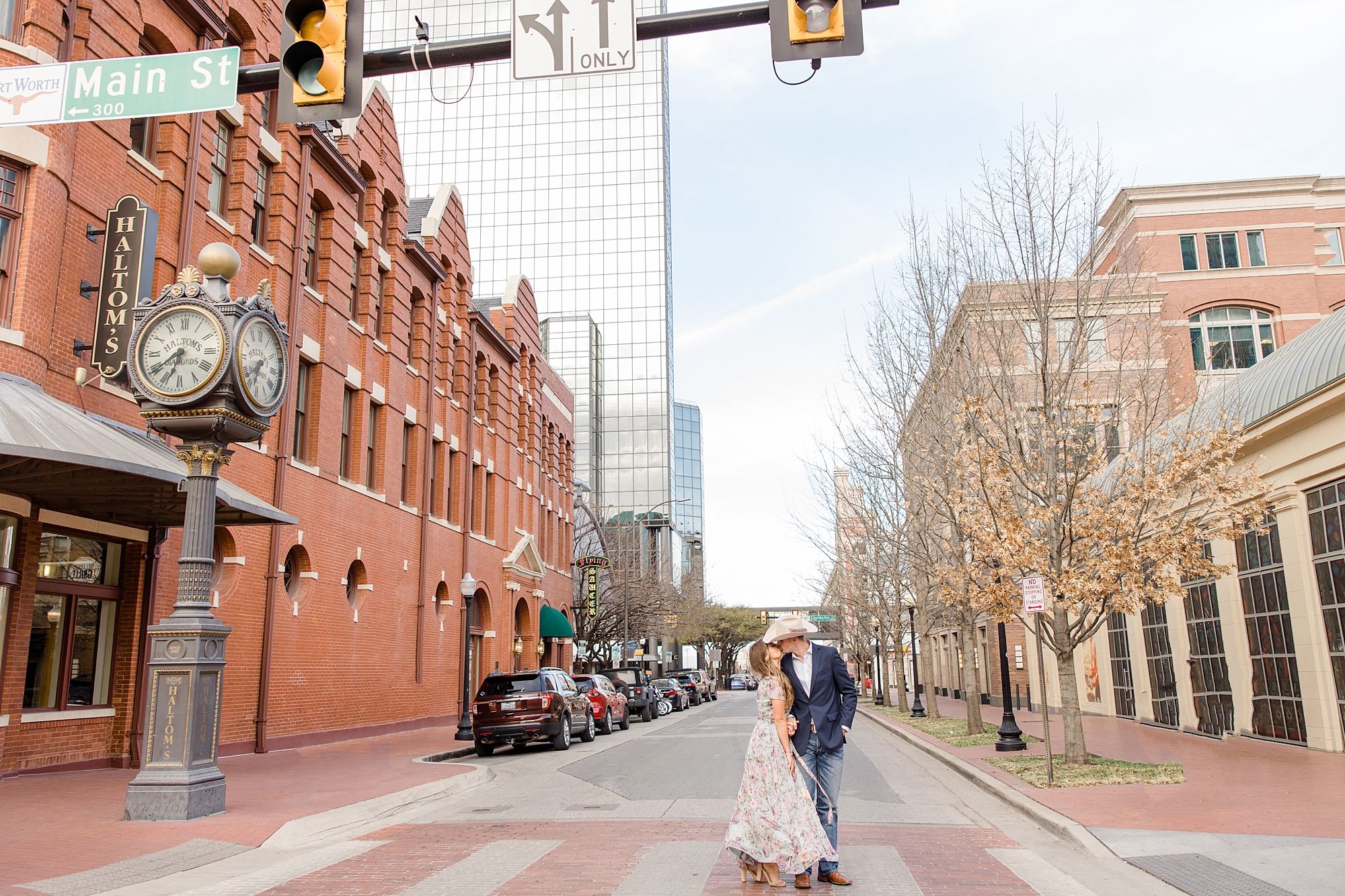 bride nd groom stand in walkway in downtown Fort Worth 