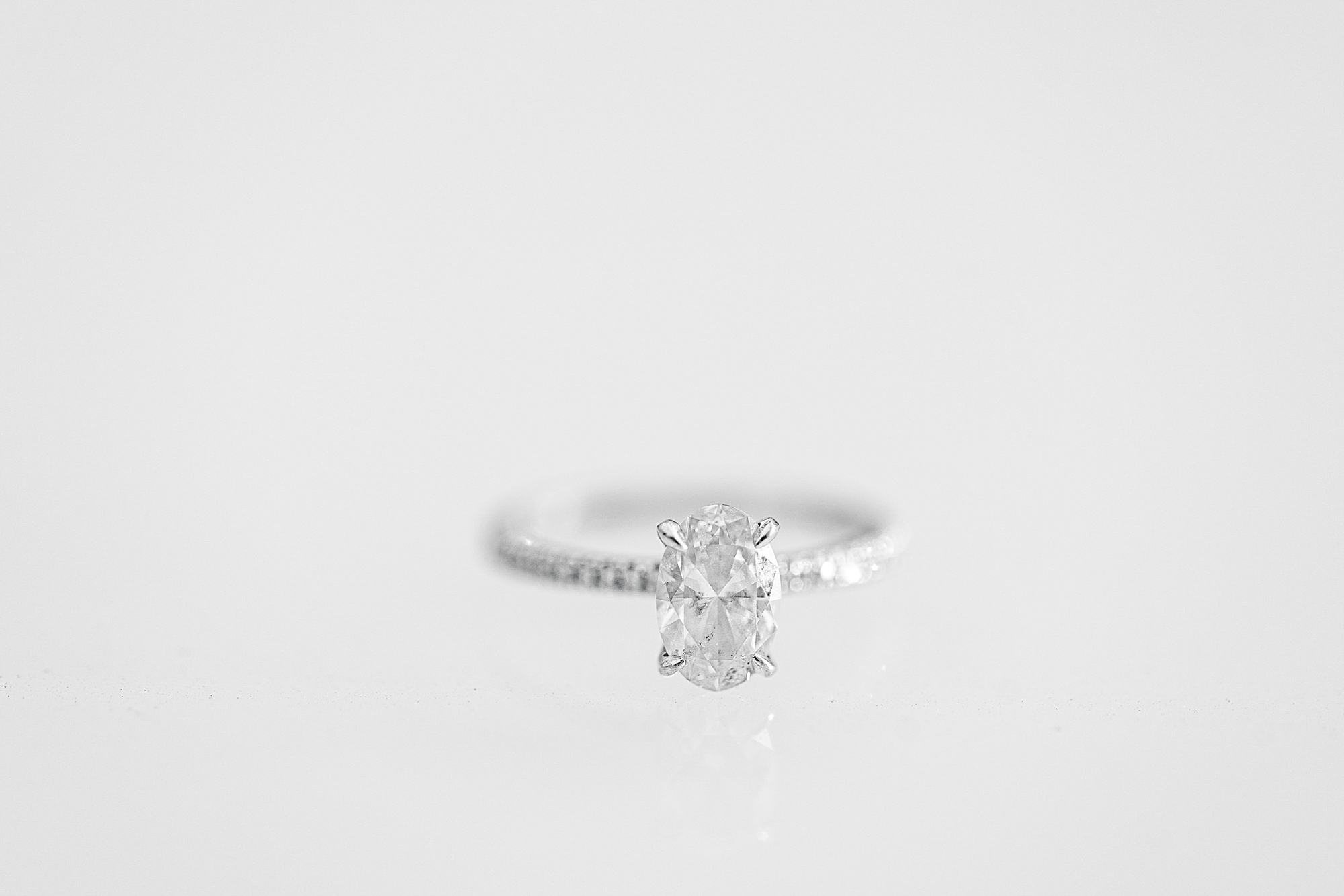diamond engagement ring rests on white step