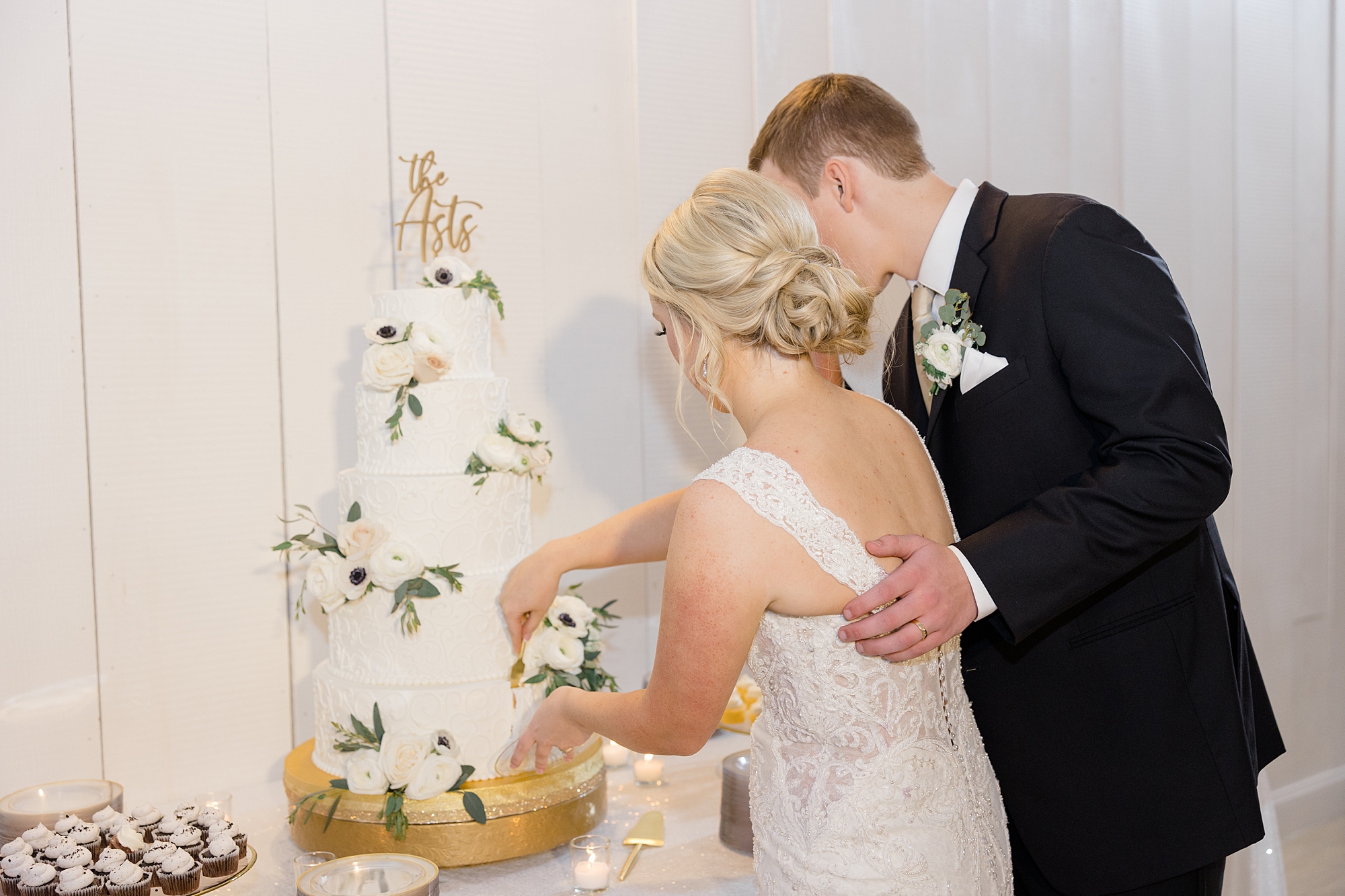 bride and groom cut wedding cake during TX wedding reception