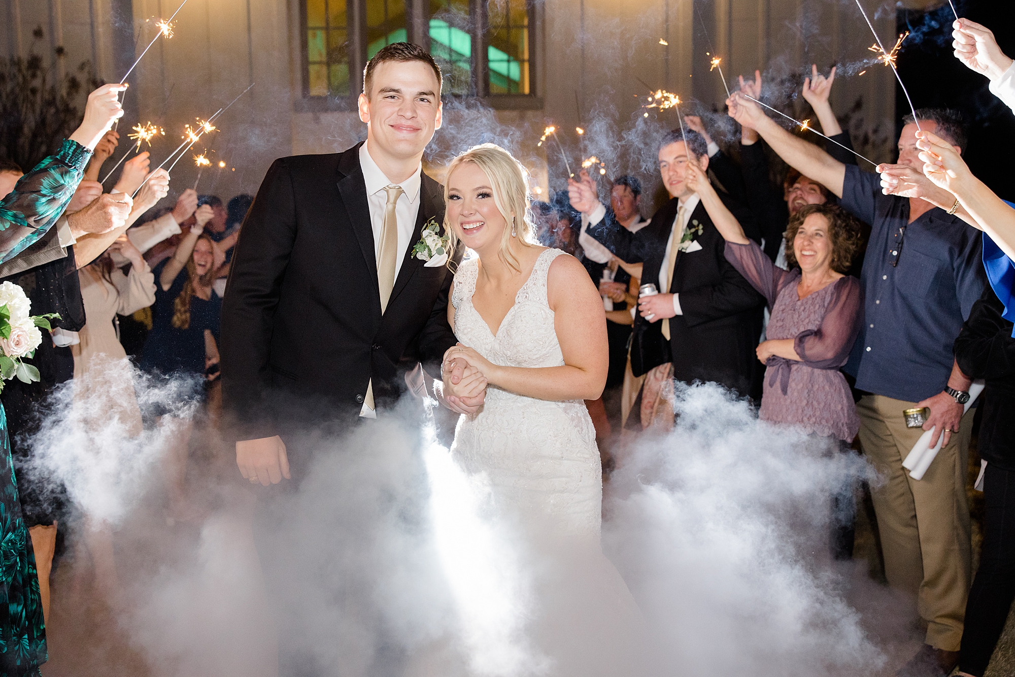 couple walks through sparklers during TX wedding reception