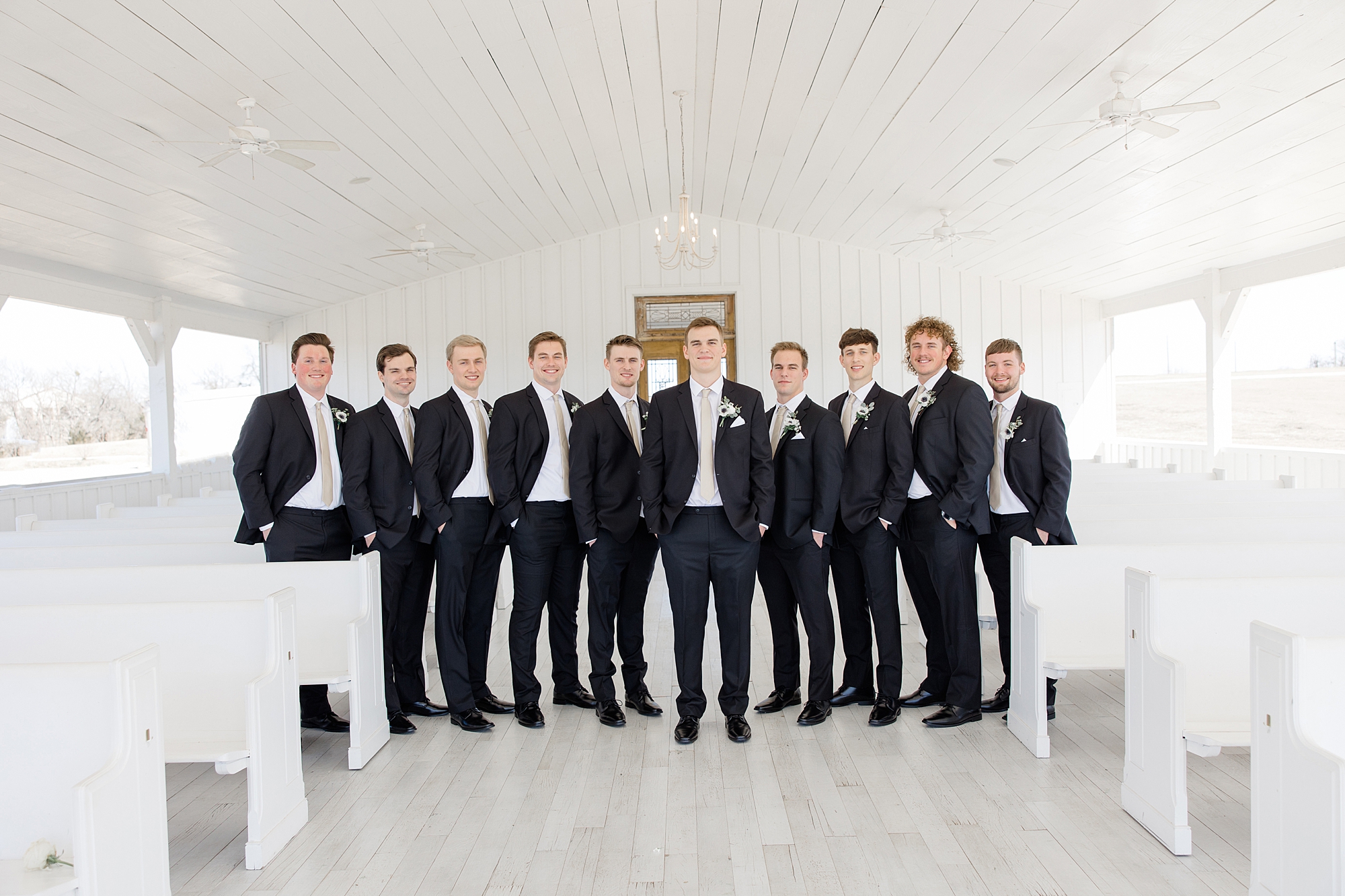 groom and groomsmen stand inside open air chapel at The Grand Ivory 