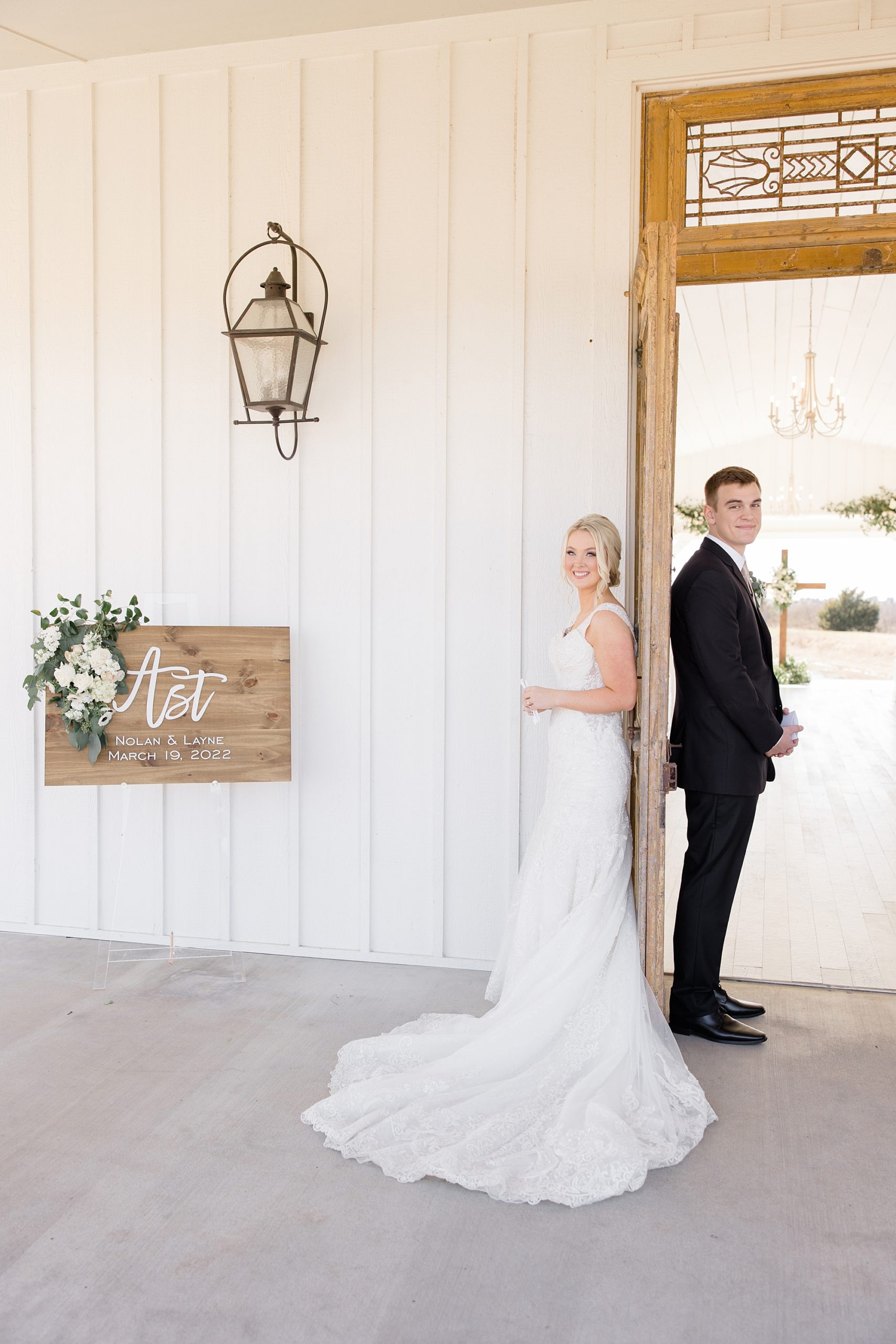 bride and groom have first touch around door