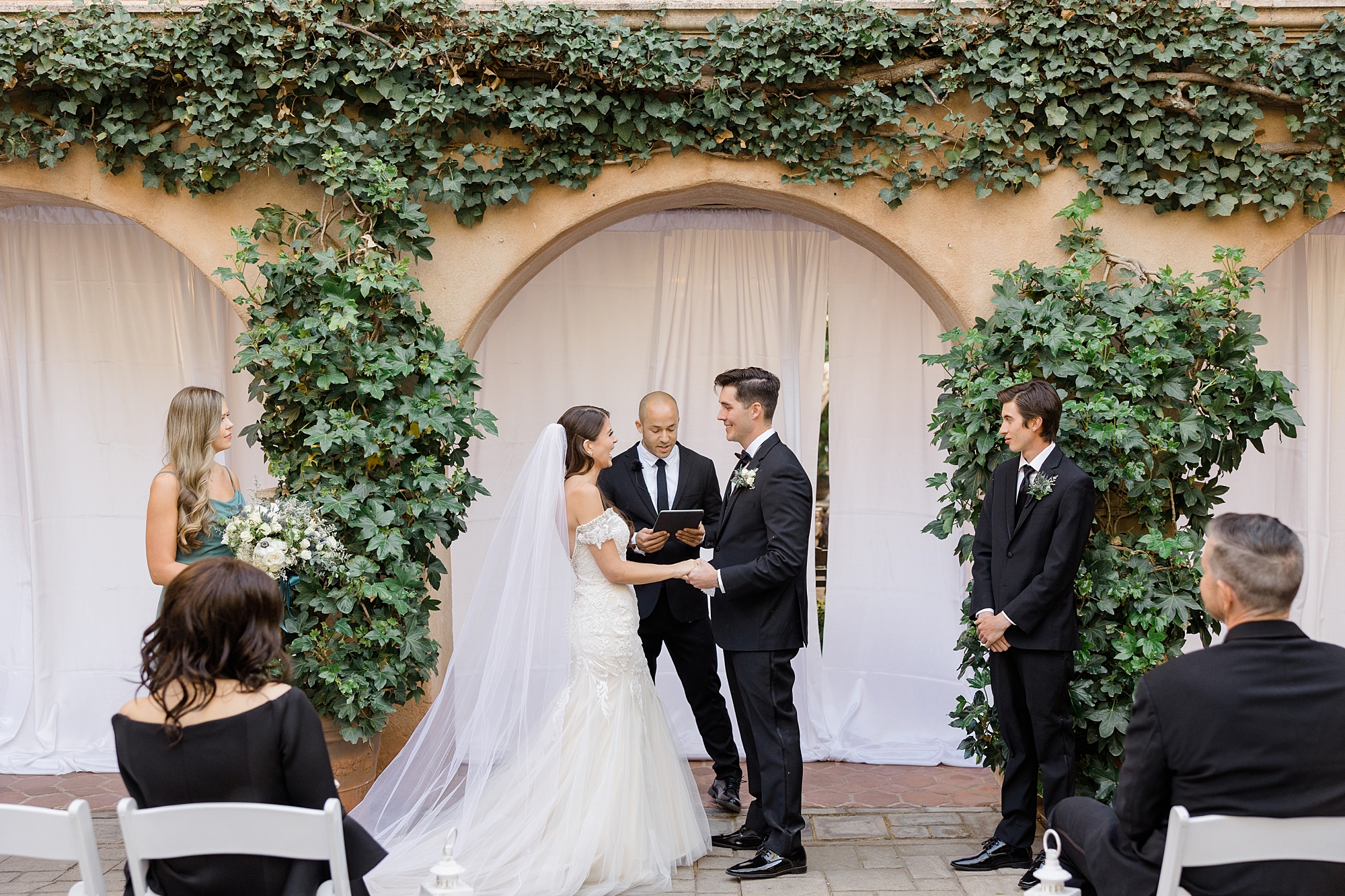 bride and groom exchange vows in courtyard at Tlaquepaque