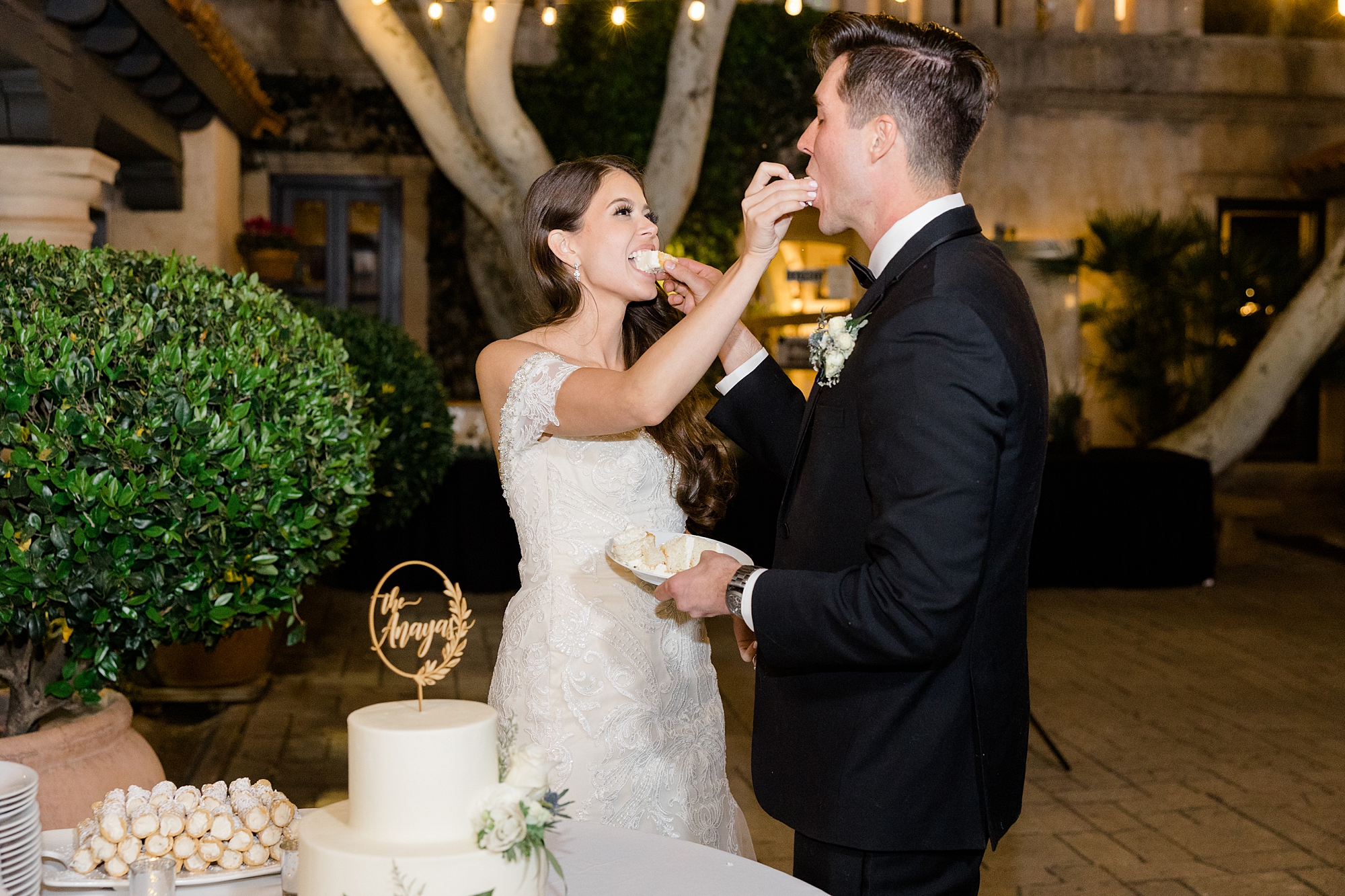 newlyweds feed each other cake at Tlaquepaque