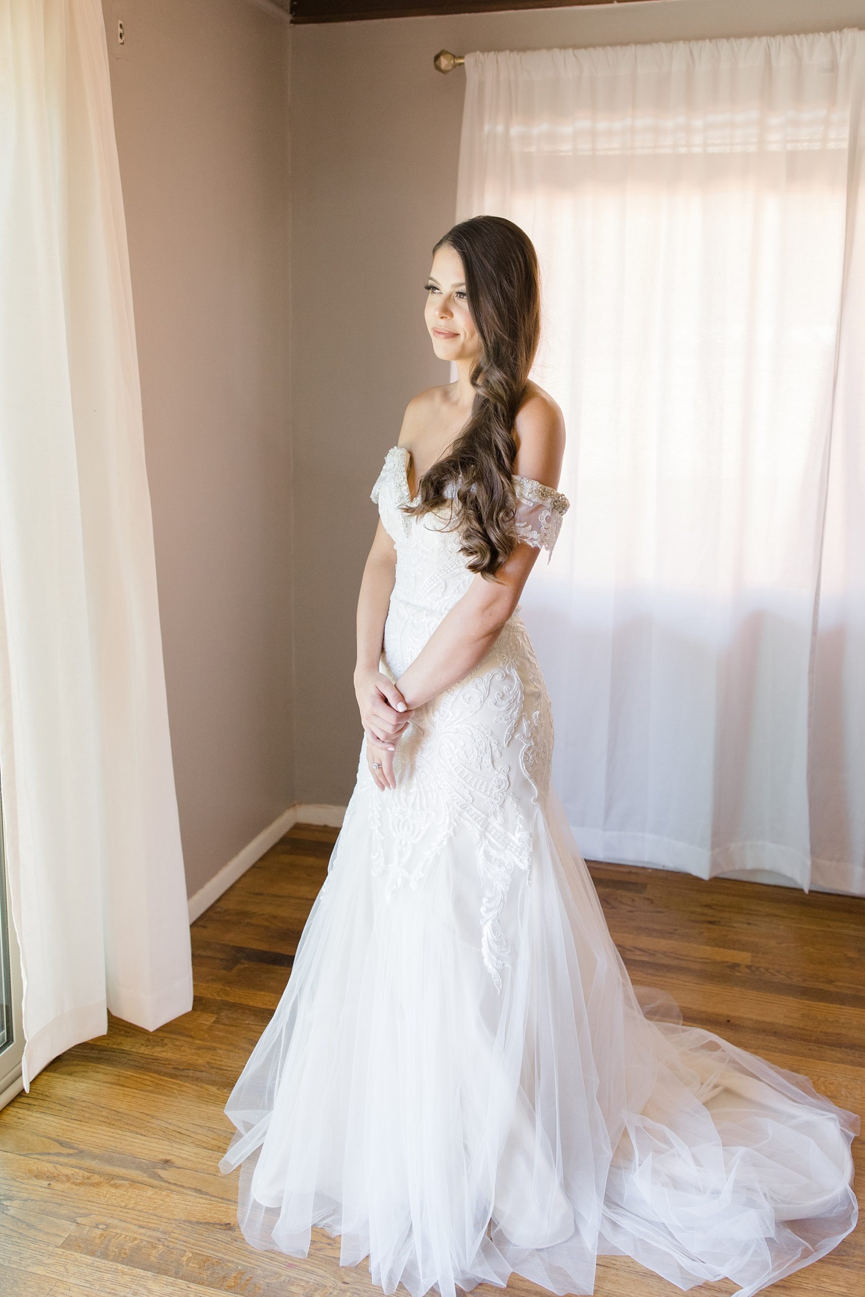 bride stands in Arizona hotel in wedding gown