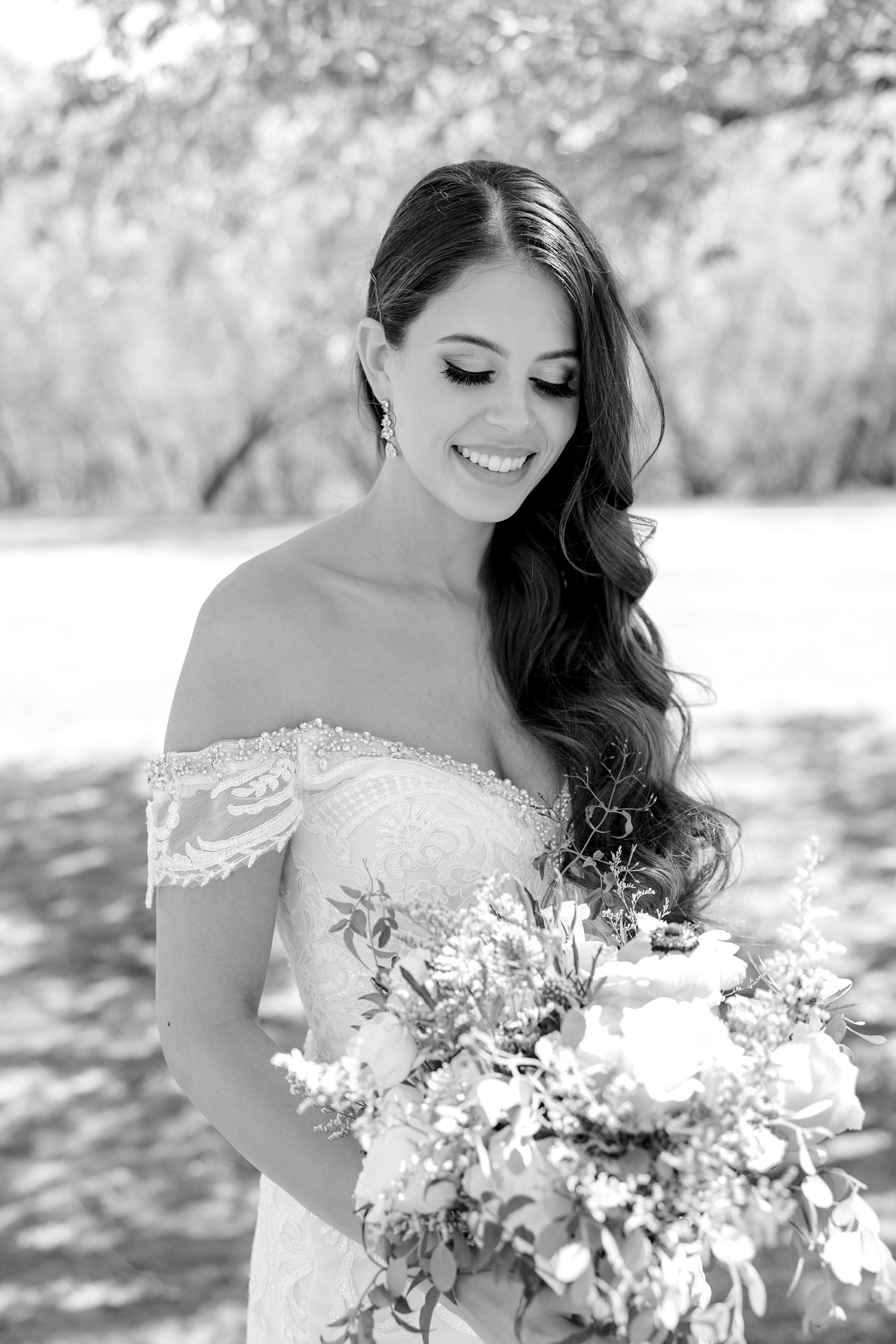  bride looks down at bouquet during AZ wedding photos