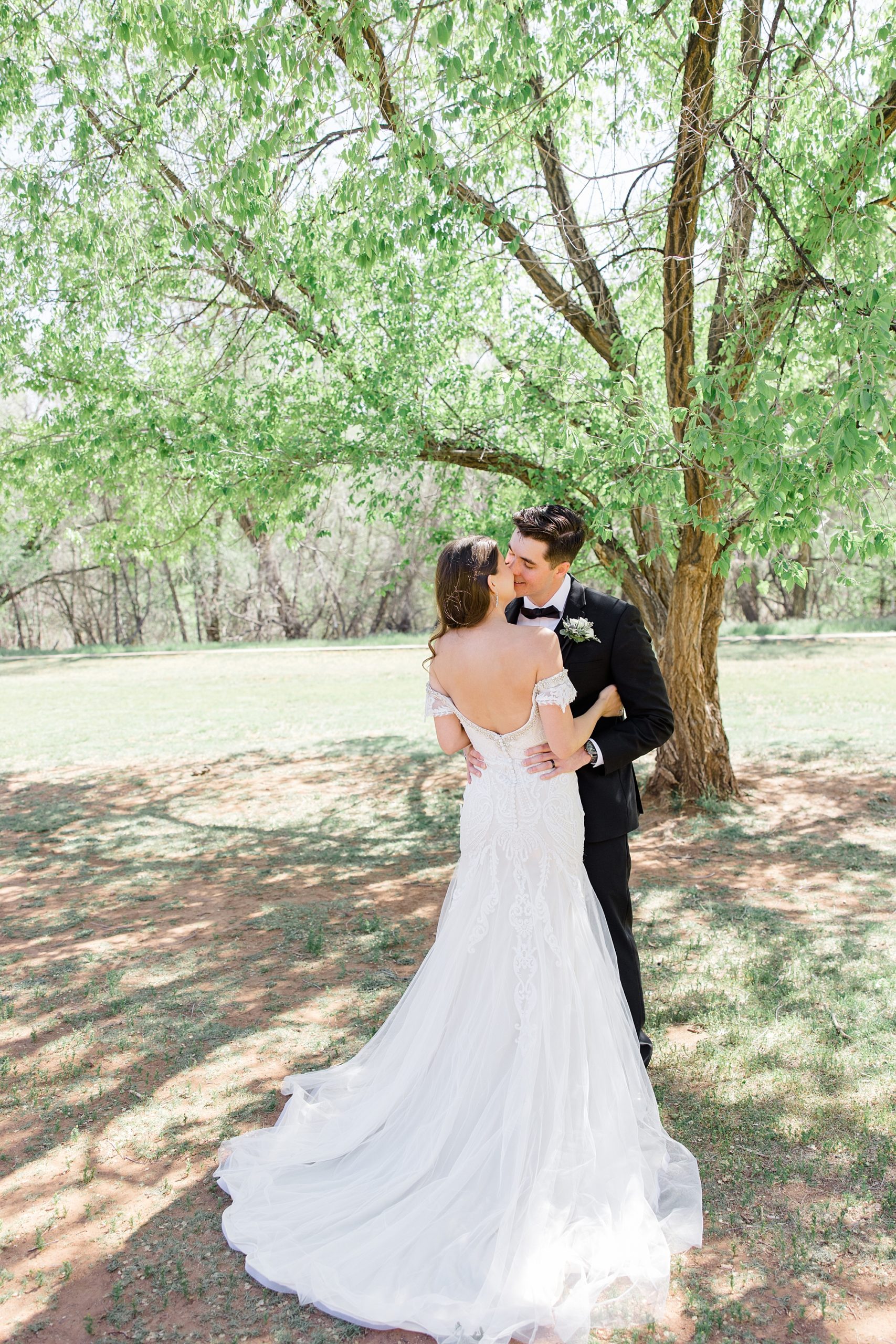 groom kisses bride during Arizona wedding photos
