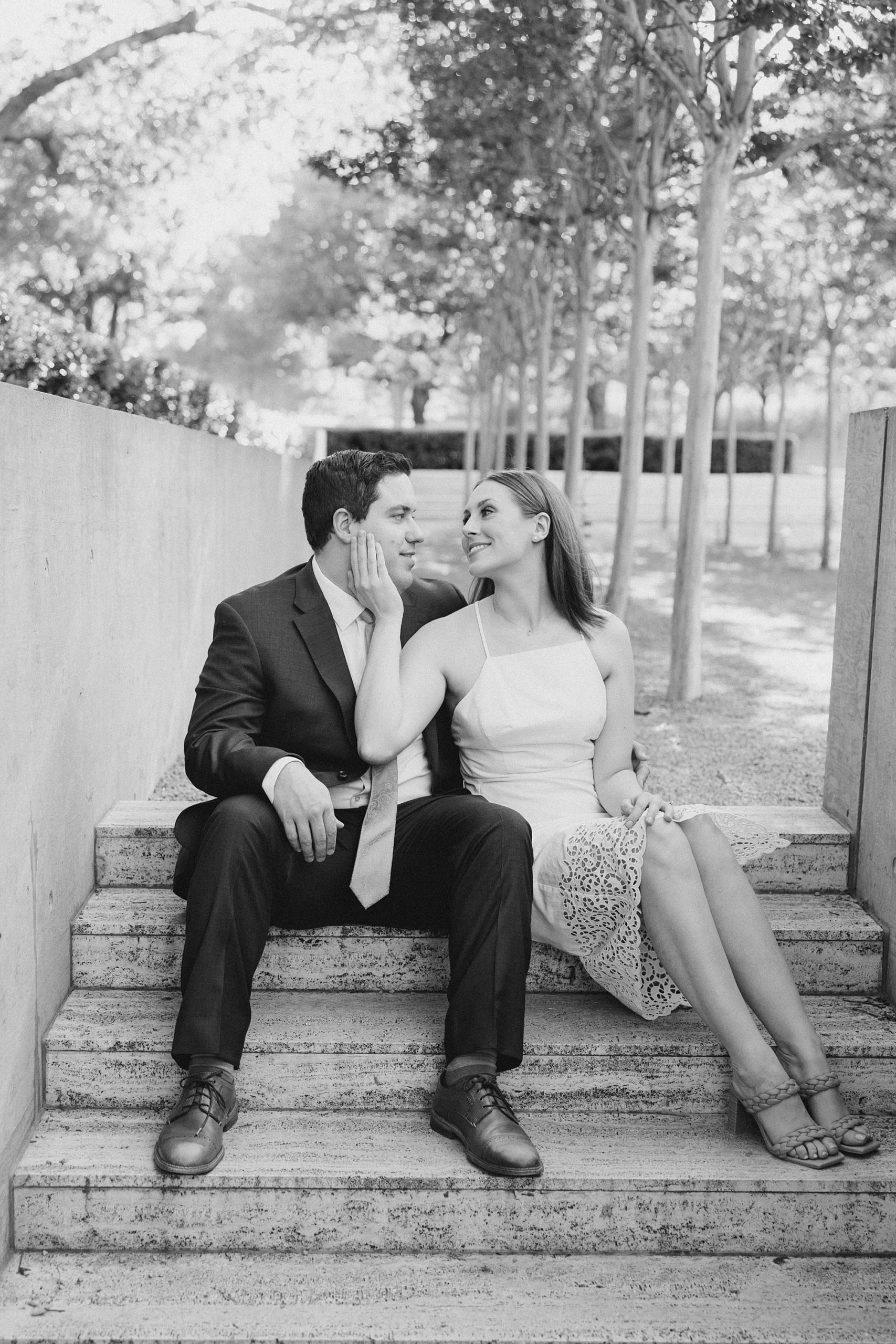 woman holds fiance's chin during Kimball Art Center engagement photos