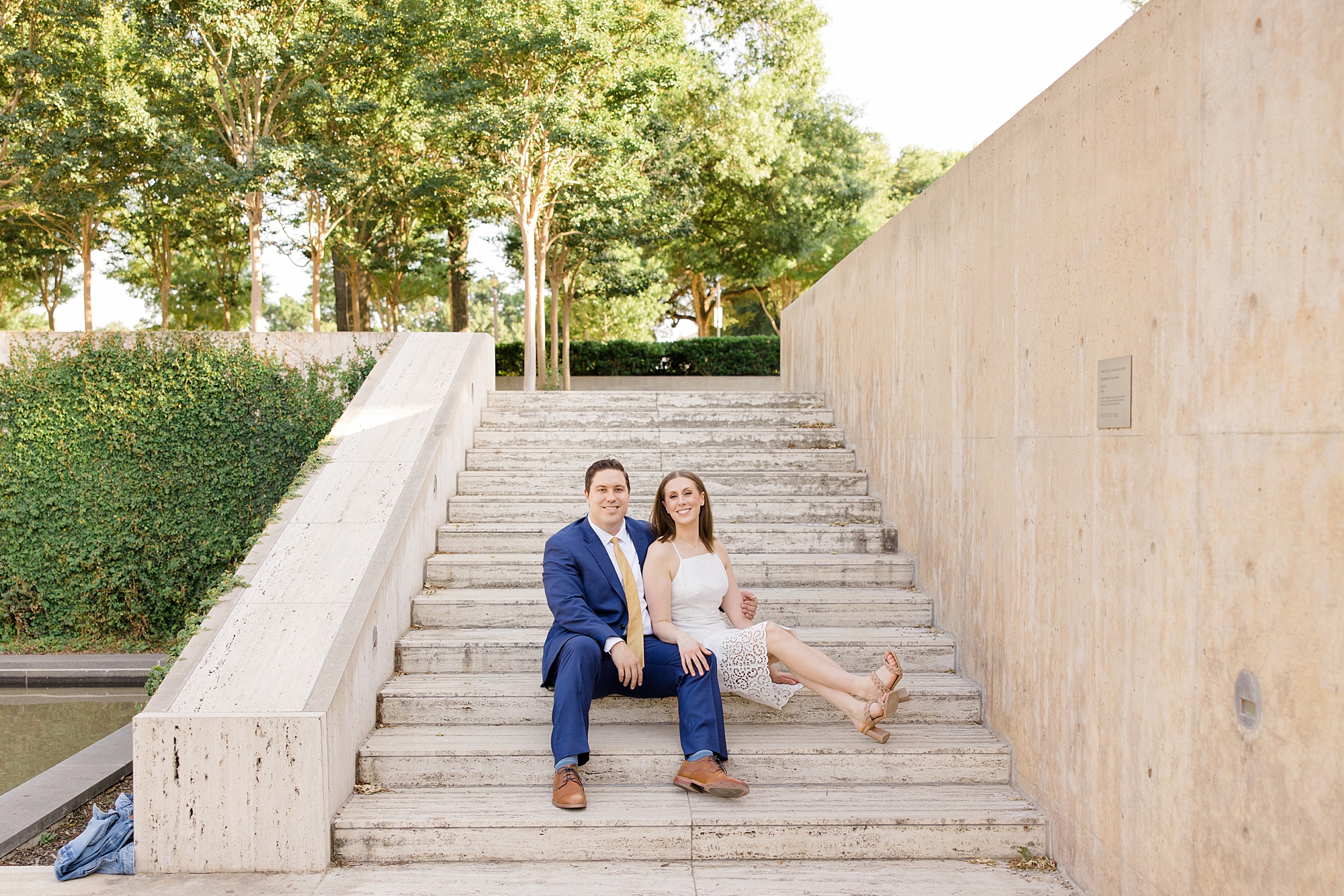 man and woman sit on steps at Kimball Art Center during spring photos