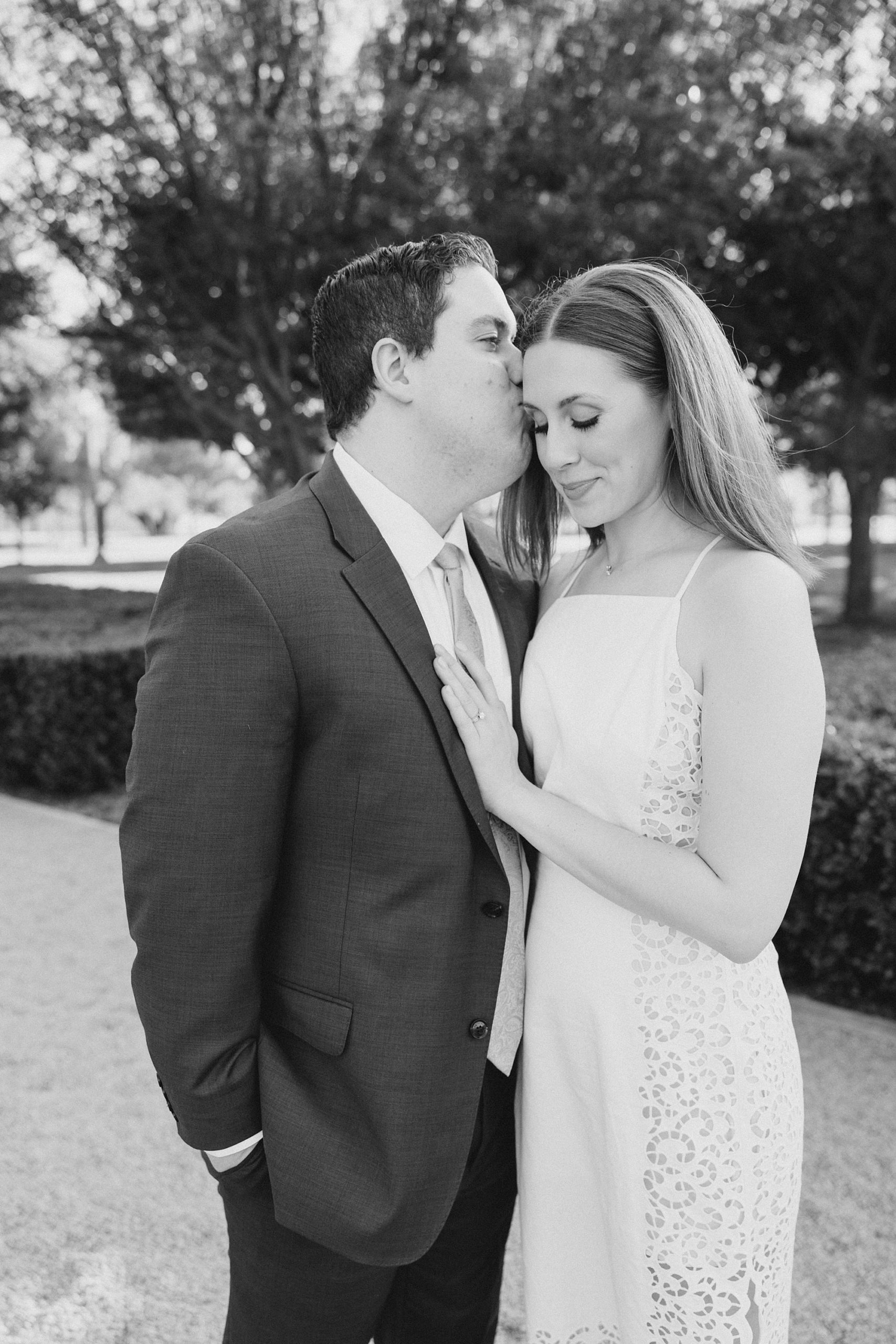 groom kisses bride's head during TX engagement session