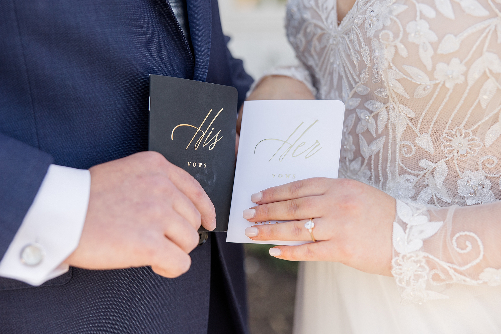 bride and groom hold custom vow booklets