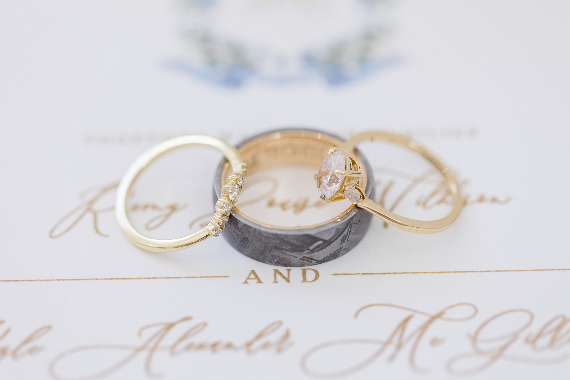wedding rings rest on classic spring invitation suite