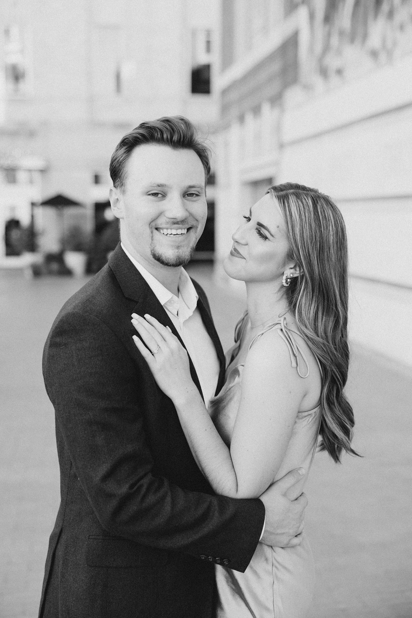 woman looks at fiancee and smiles during Sundance Square engagement photos