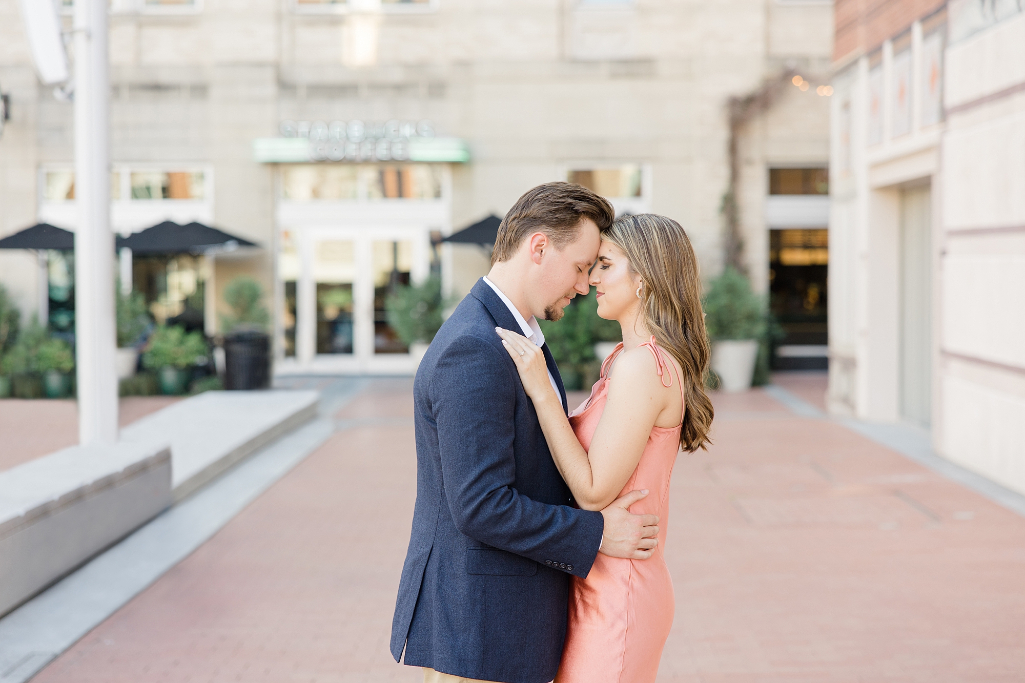 engaged couple leans heads together during Sundance Square engagement session