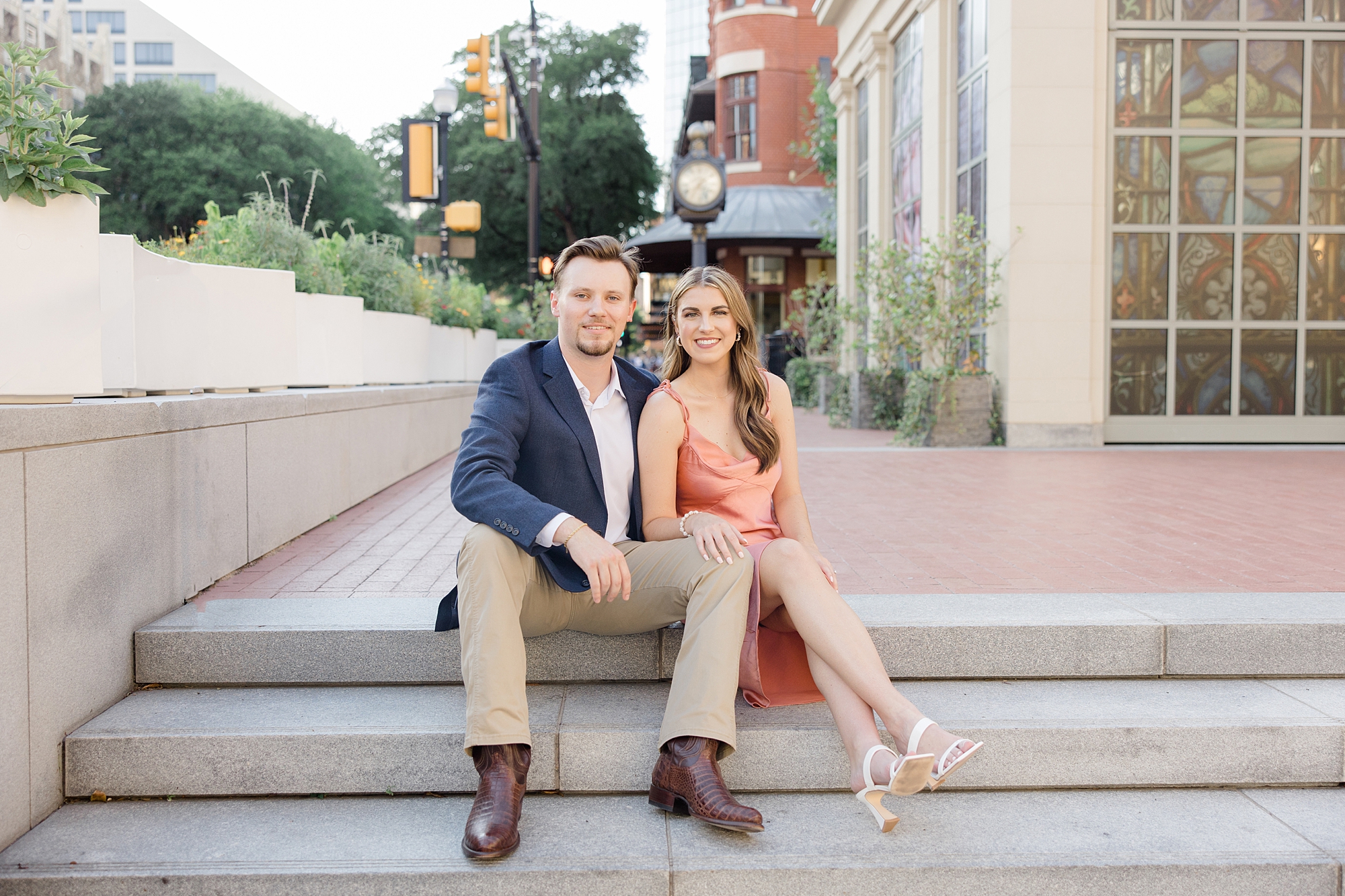 bride and groom sit on steps in Sundance Square