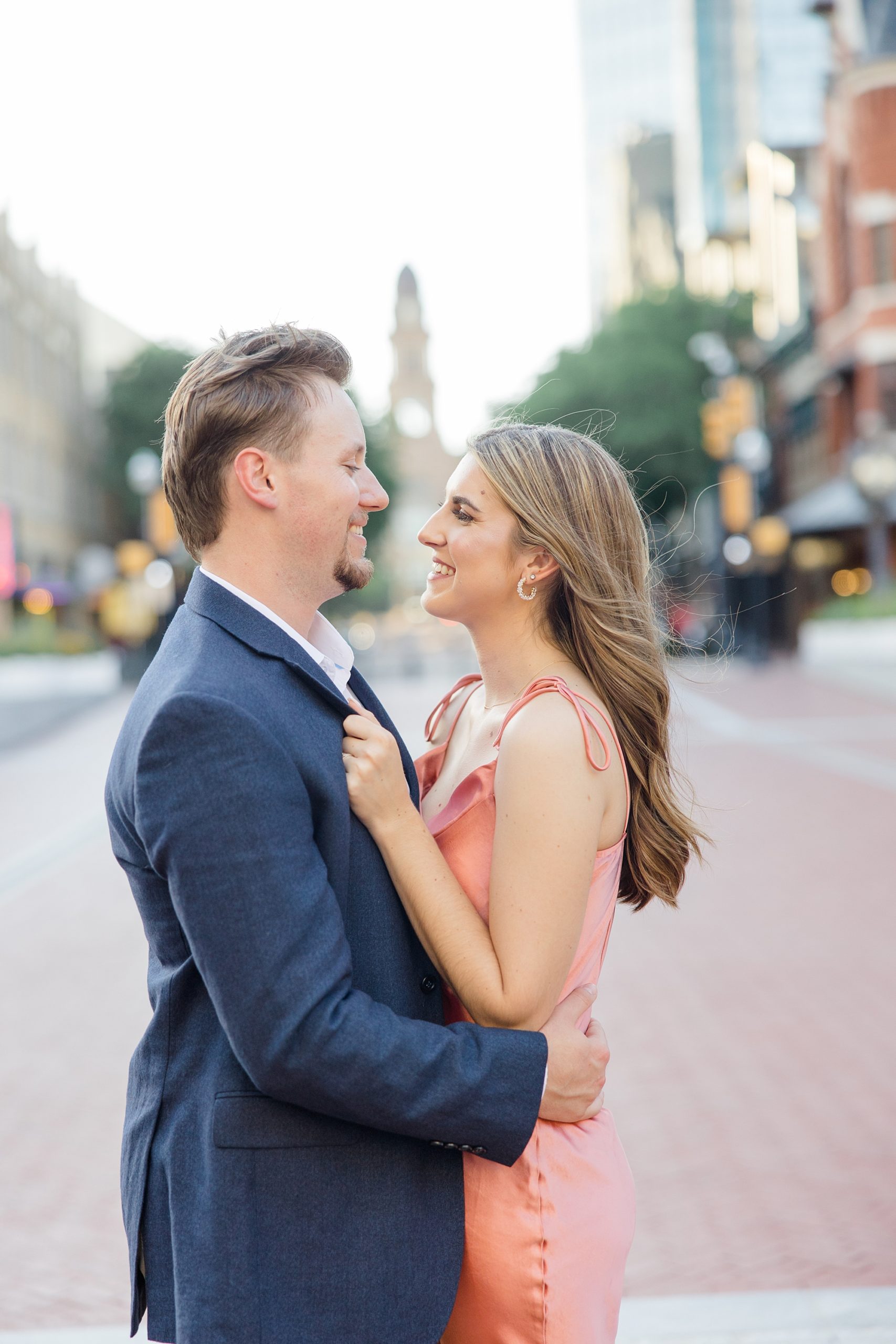 couple laughs together during photos in Sundance Square