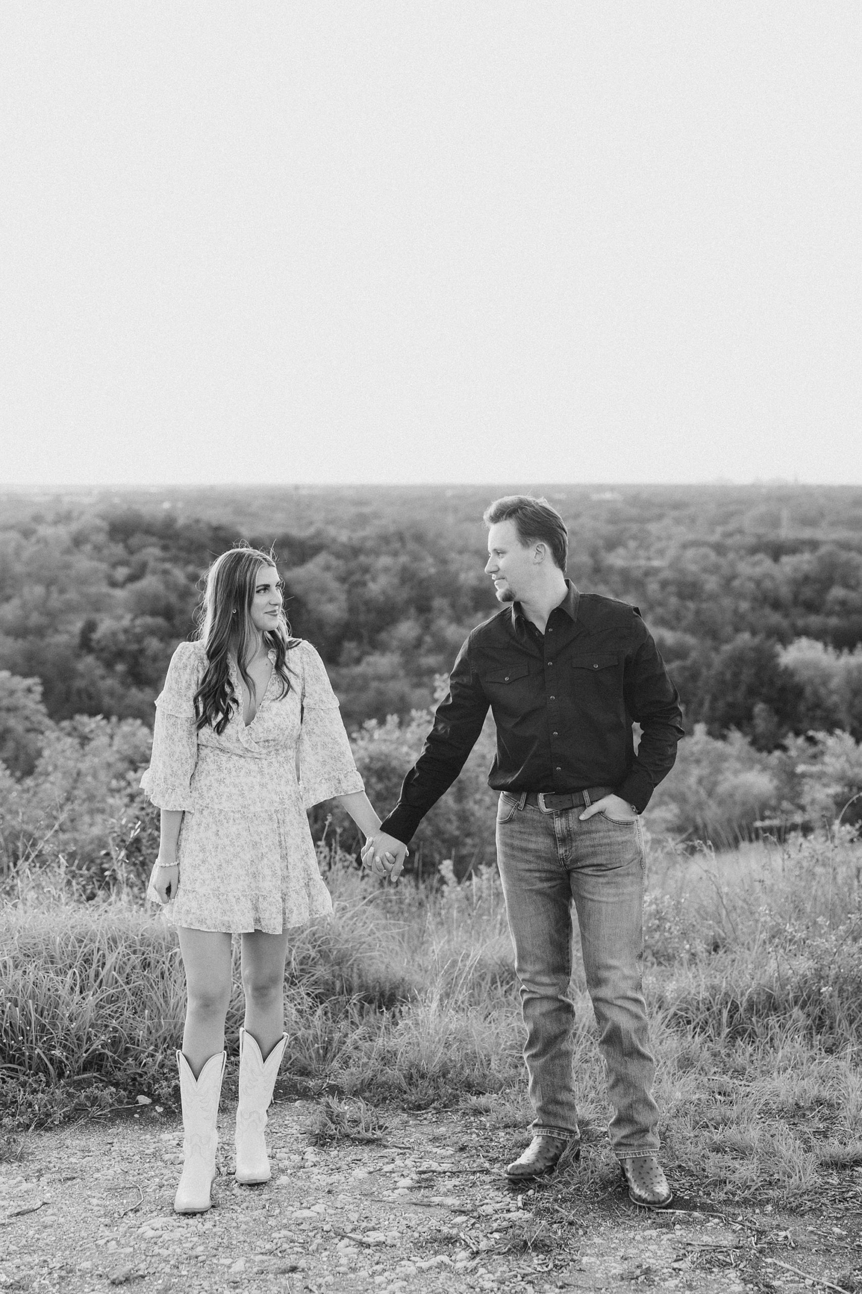 engage couple walks down hill during Fort Worth TX engagement session