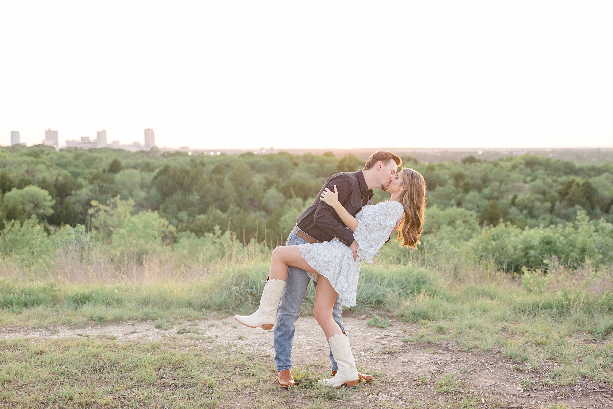groom dips bride in cowboy boots during kiss