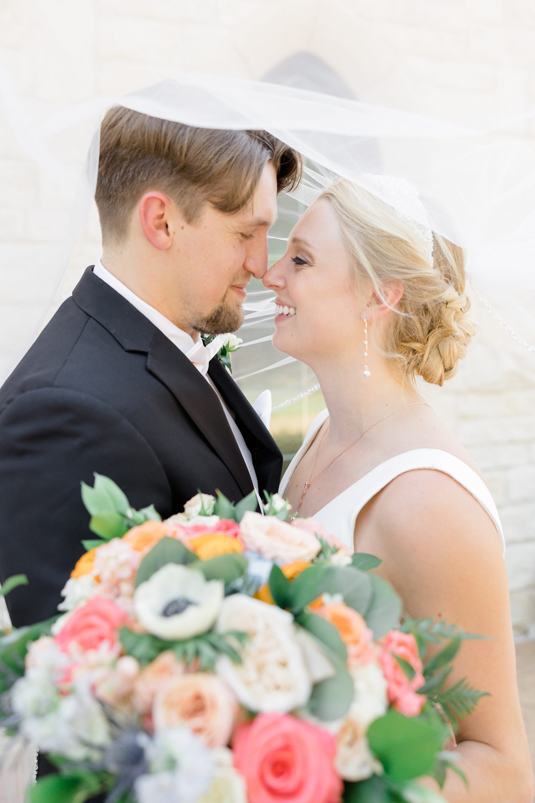 newlyweds lean heads together touching noses 