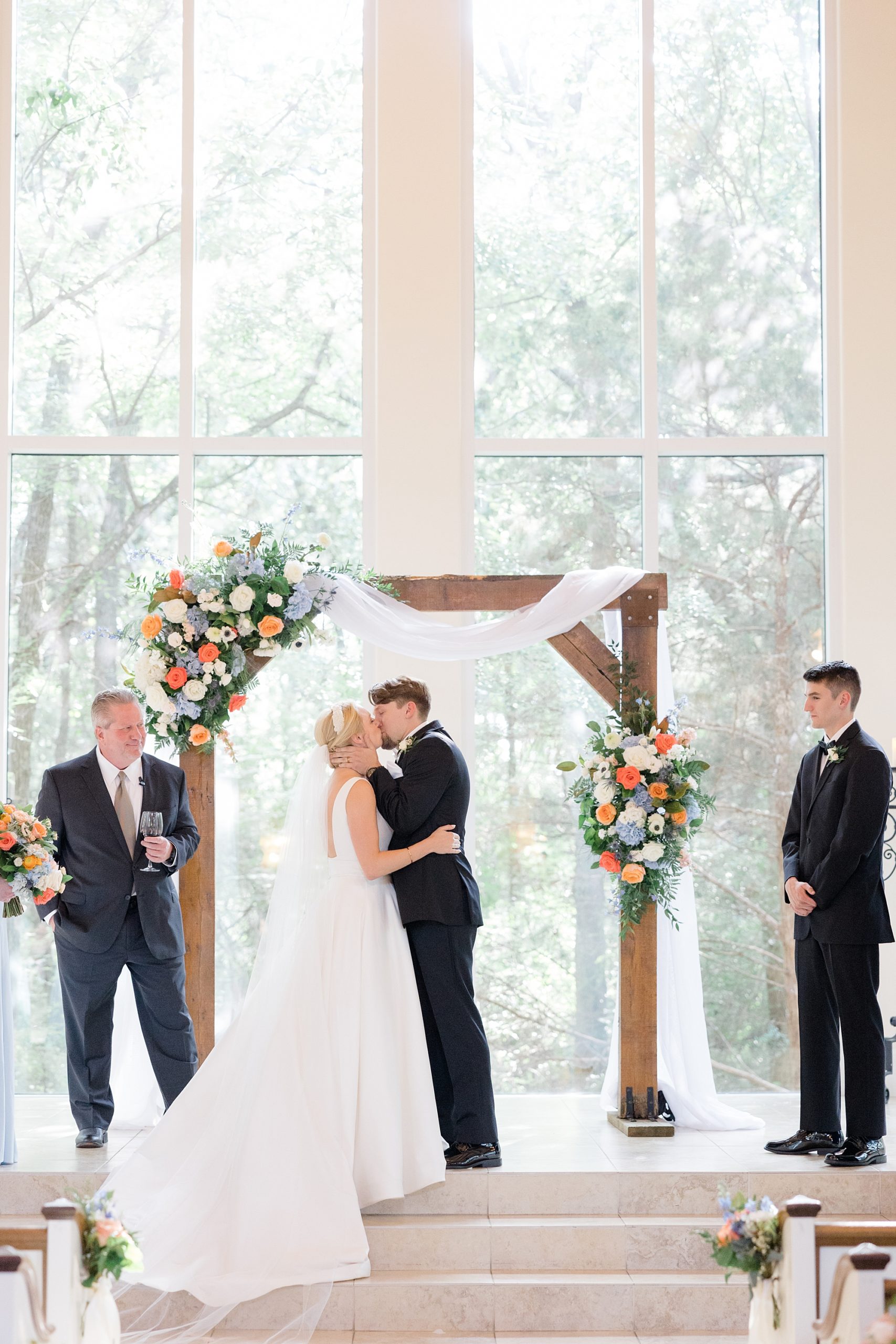 couple kisses during chapel wedding in Texas