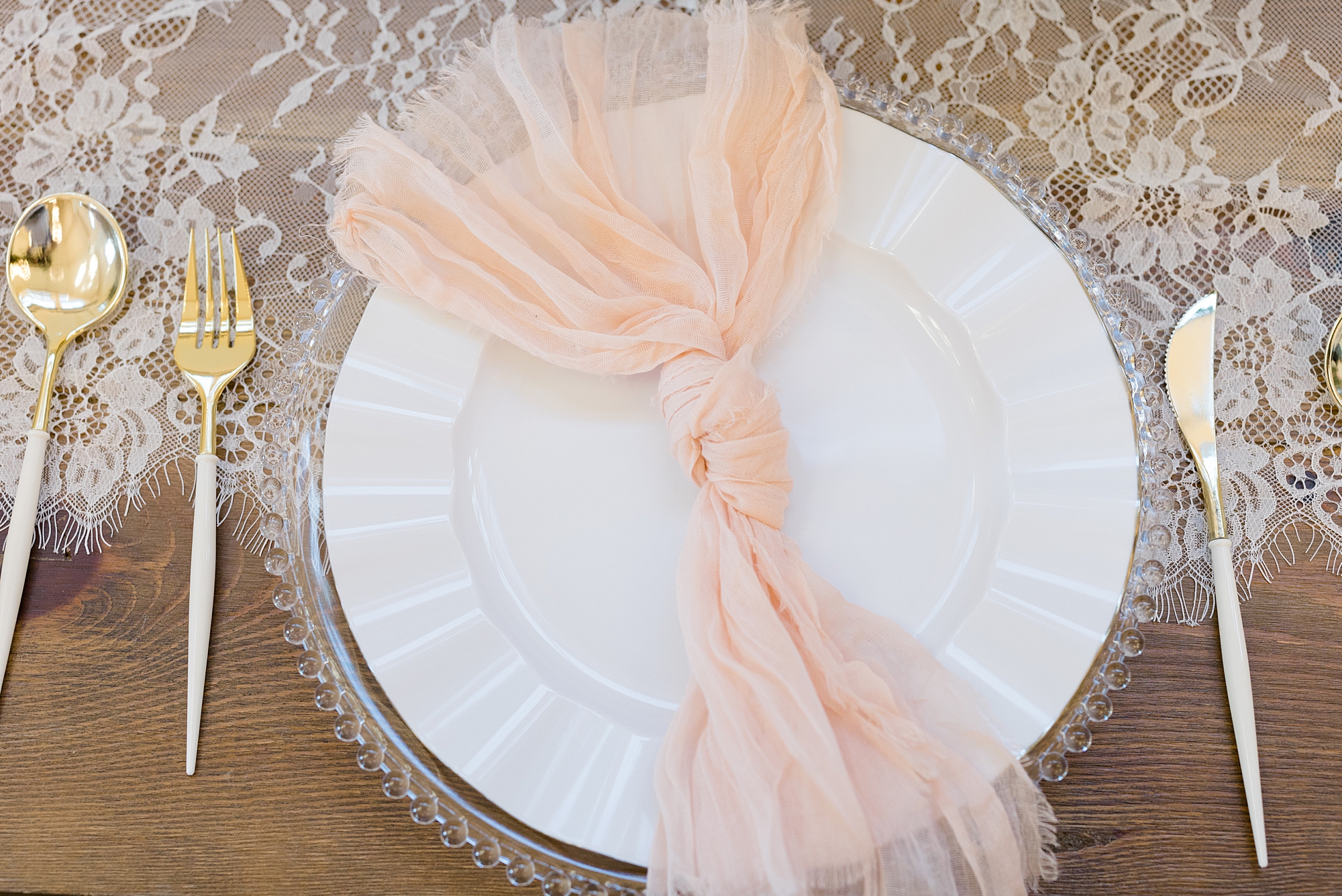 place settings with blush napkins at Oak + Ivy