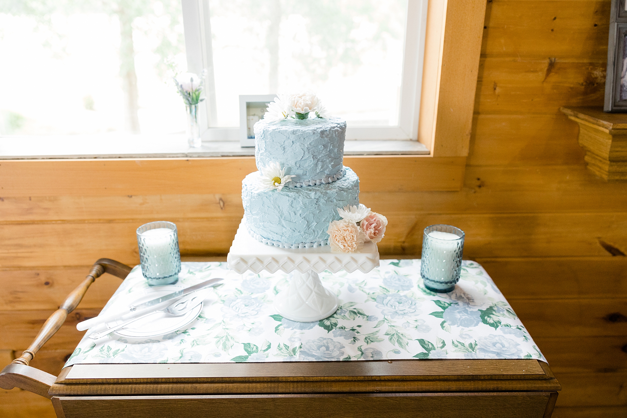 tiered wedding cake with blue icing for rustic New York wedding reception
