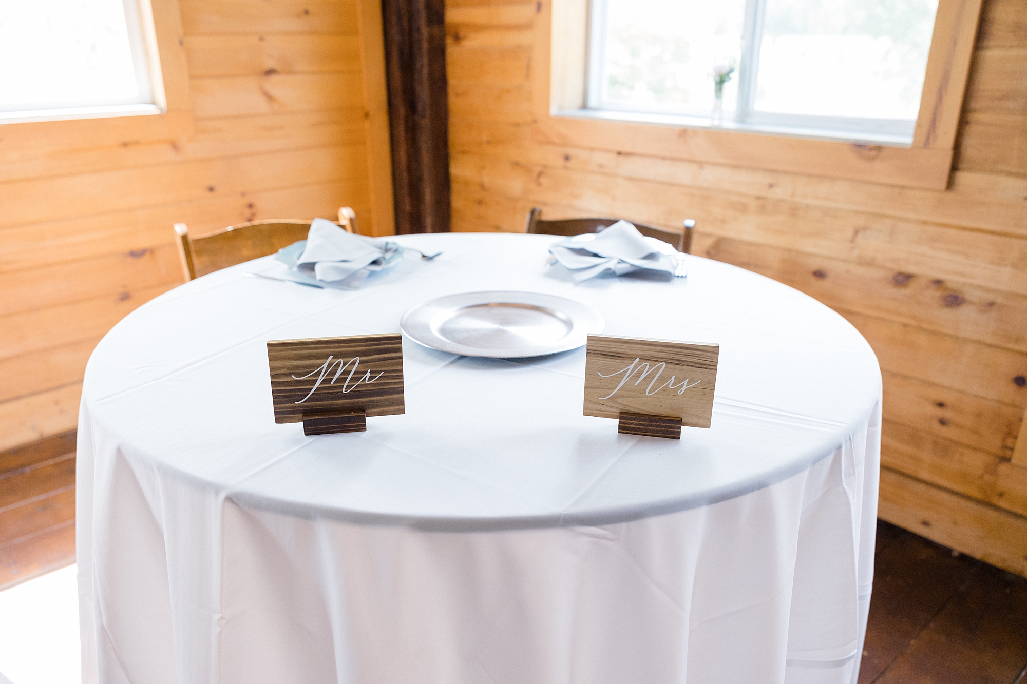 sweetheart table with wooden signs for rustic New York wedding reception