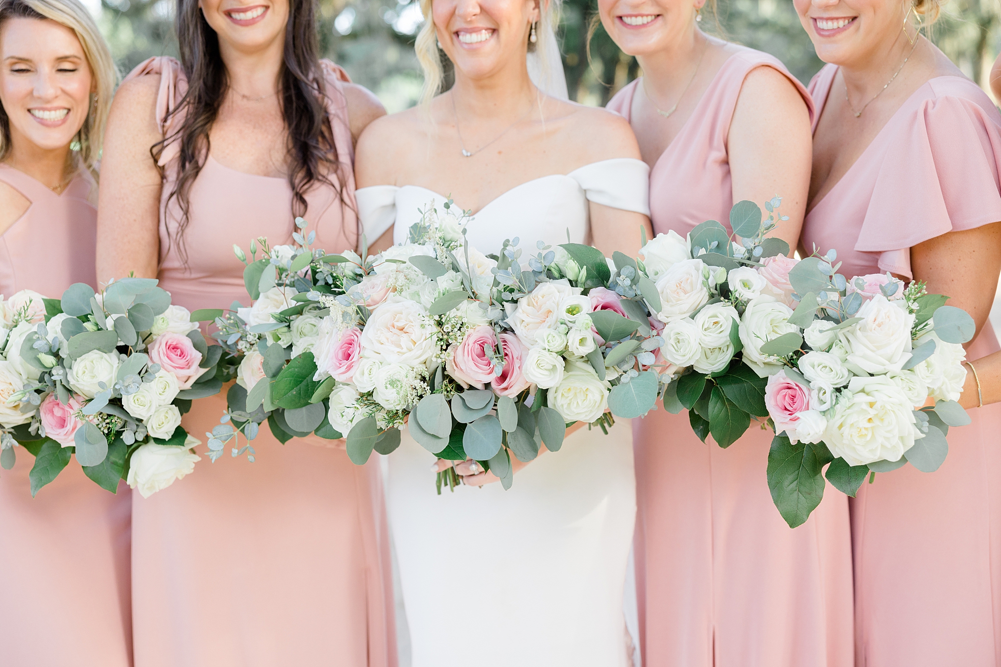 bride holds bouquet of white and pink flowers for summer southern wedding day
