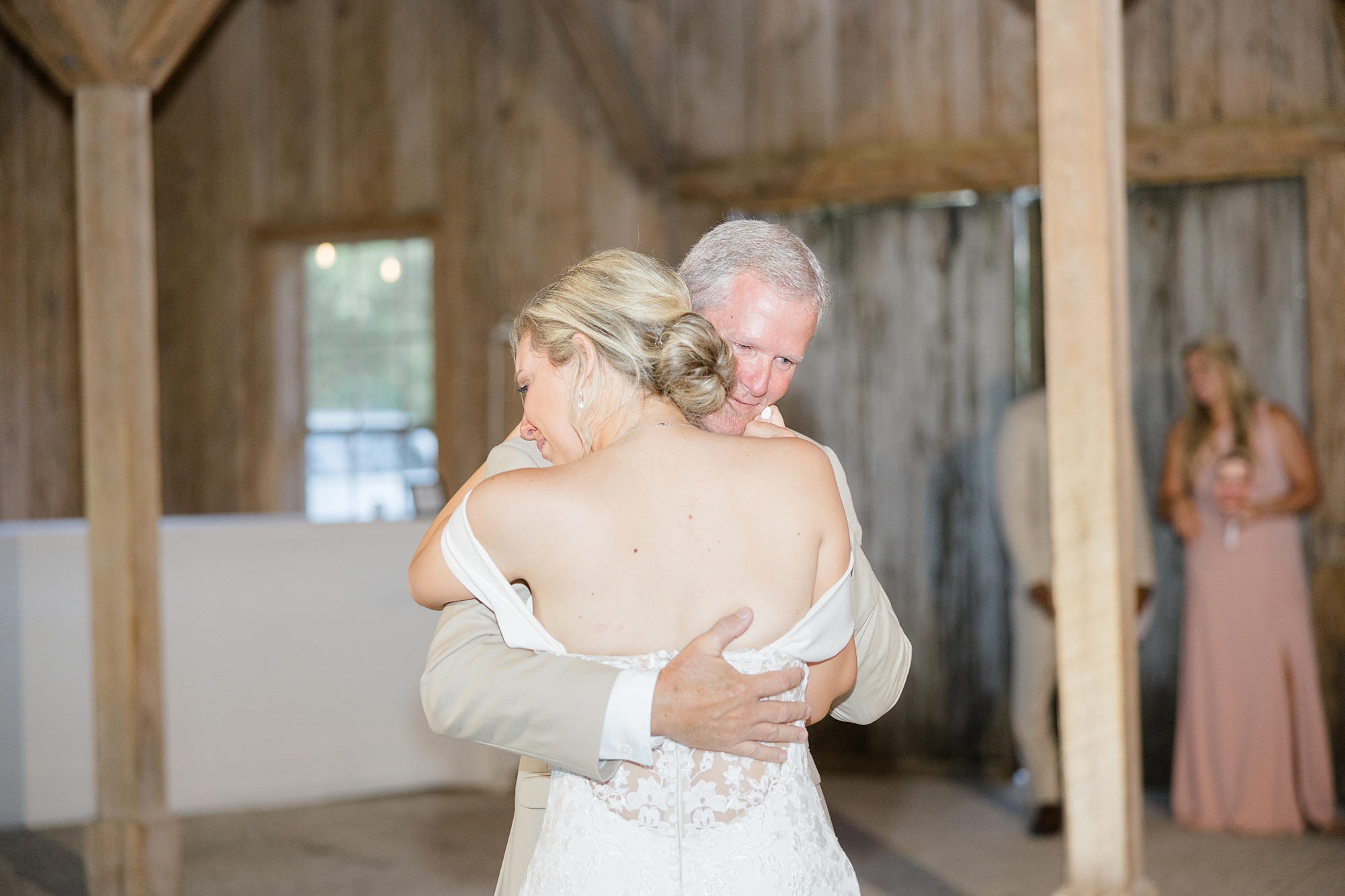 bride hugs dad during reception