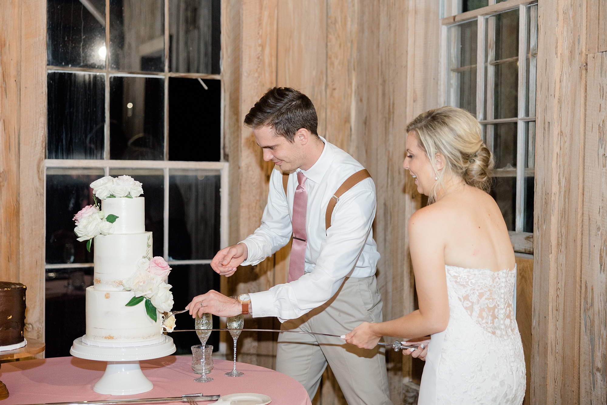 bride and groom cut wedding cake during Charleston SC wedding reception 