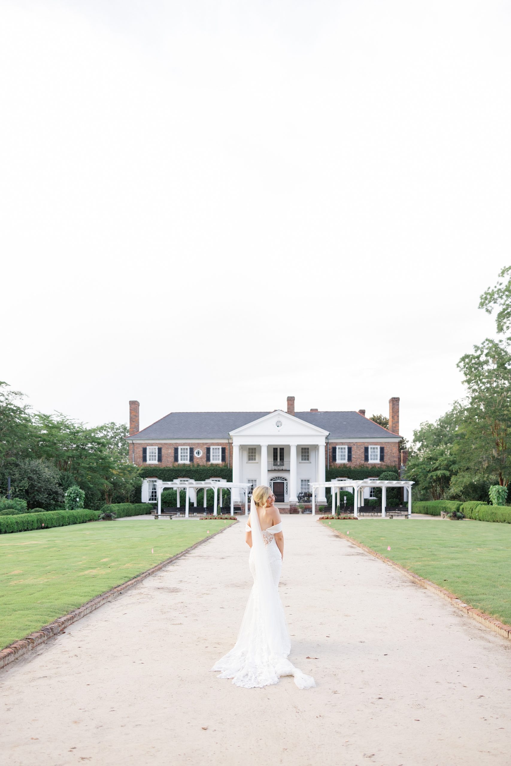 bride poses outside Boone Hall