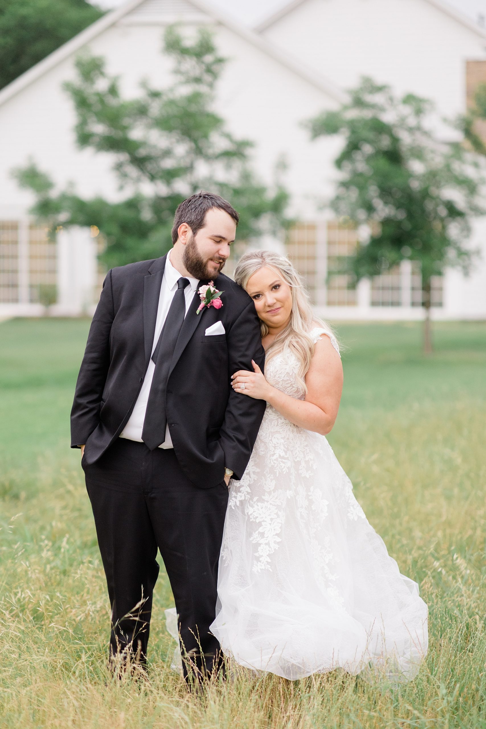 bride leans head on groom's arm during Willow Creek wedding portraits 