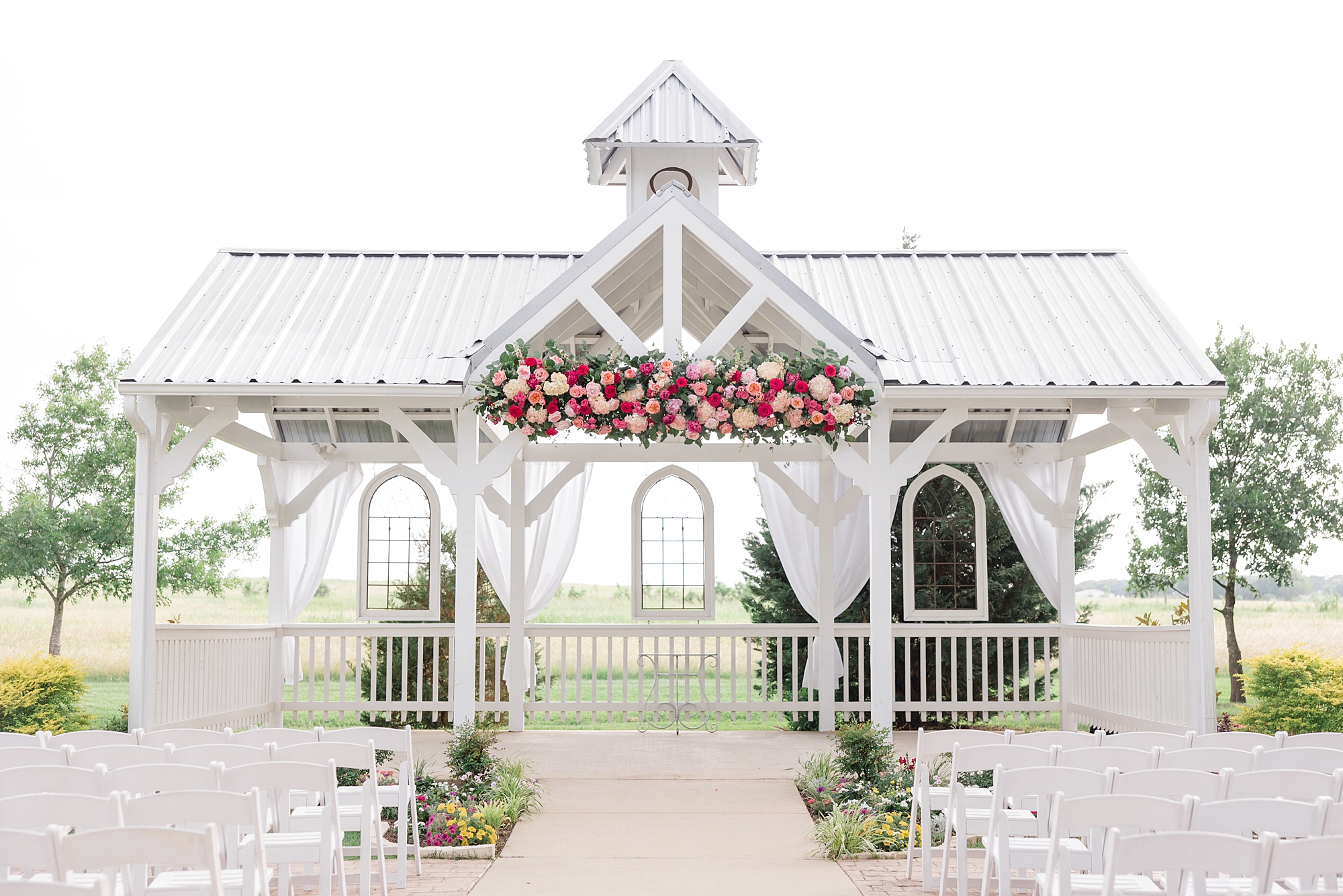 ceremony site at Willow Creek with arbor with pink flowers