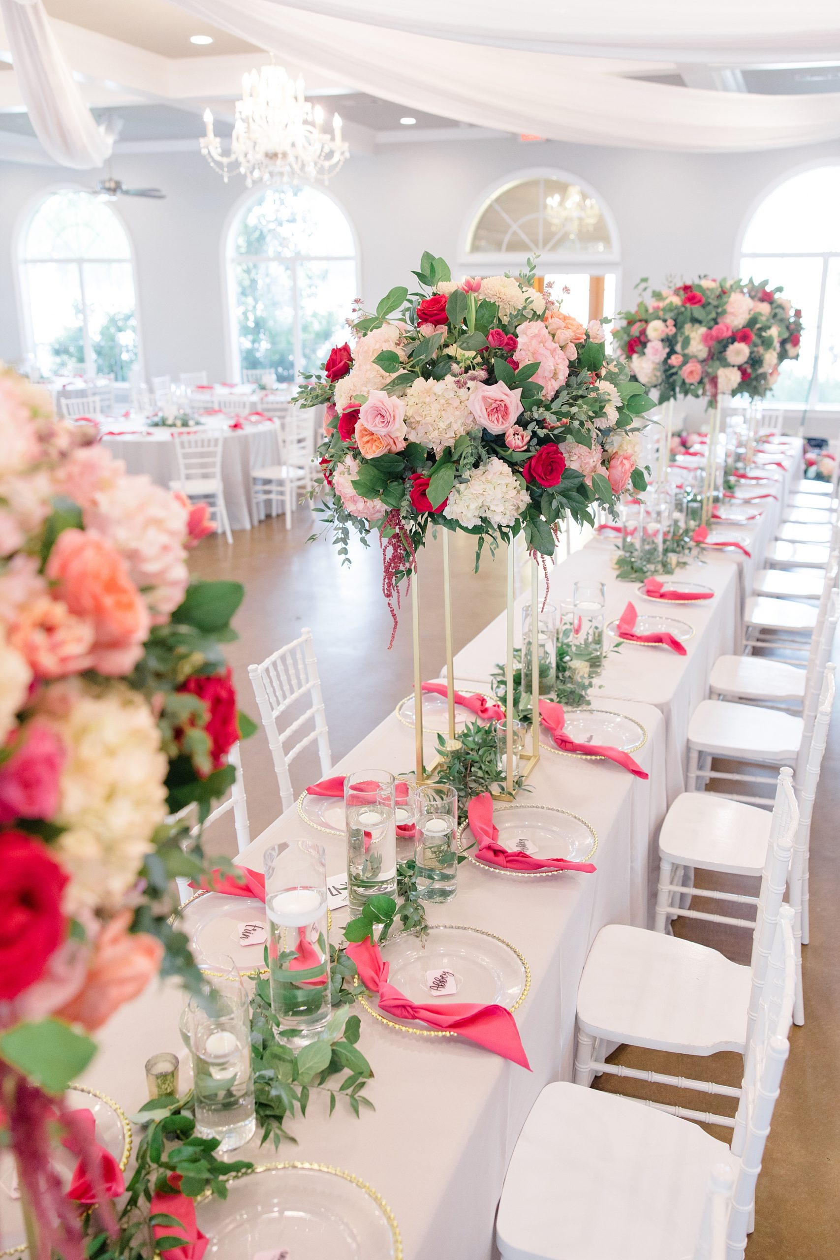 tall floral centerpieces with pink flowers and greenery table runner