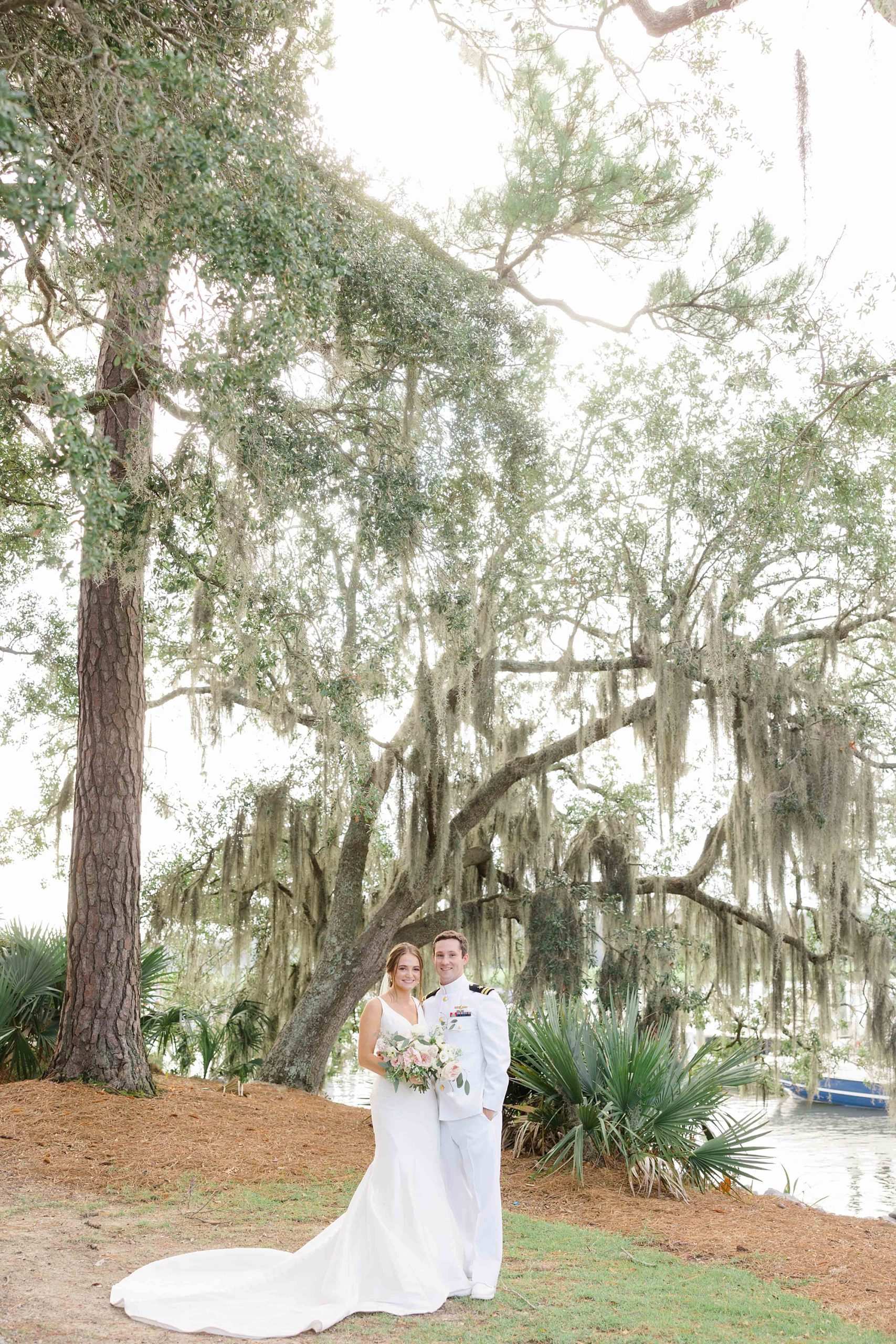 bride and groom stand by Spanish moss at Club Creek at Ion