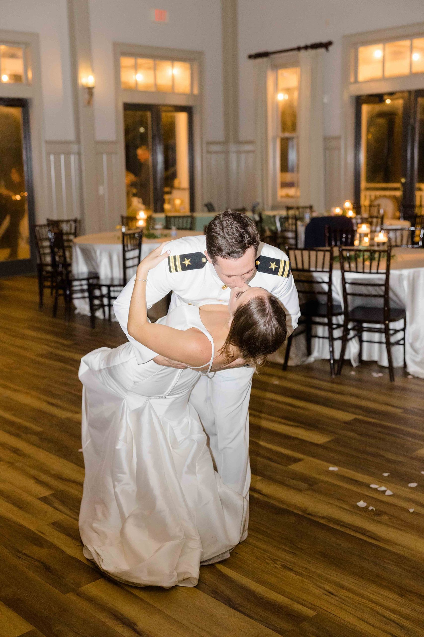 groom dips bride in reception space at Club Creek at Ion