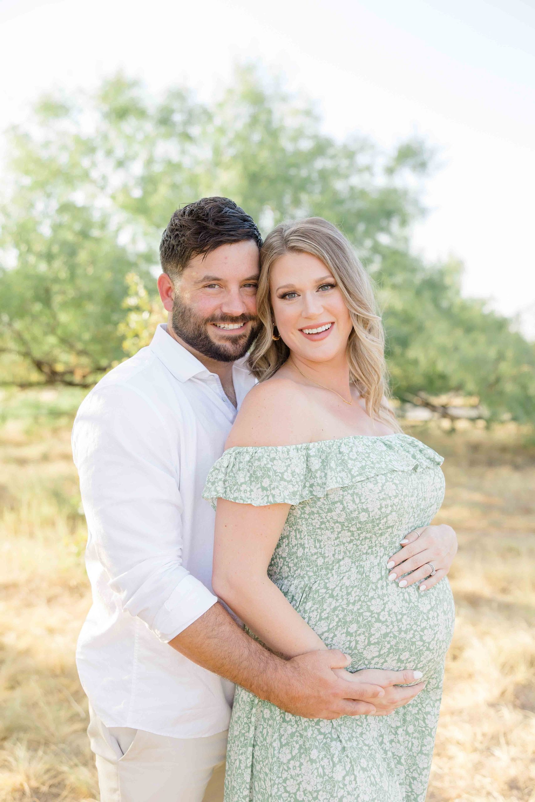 Texas couple smiles and hugs during Murrell Park maternity session