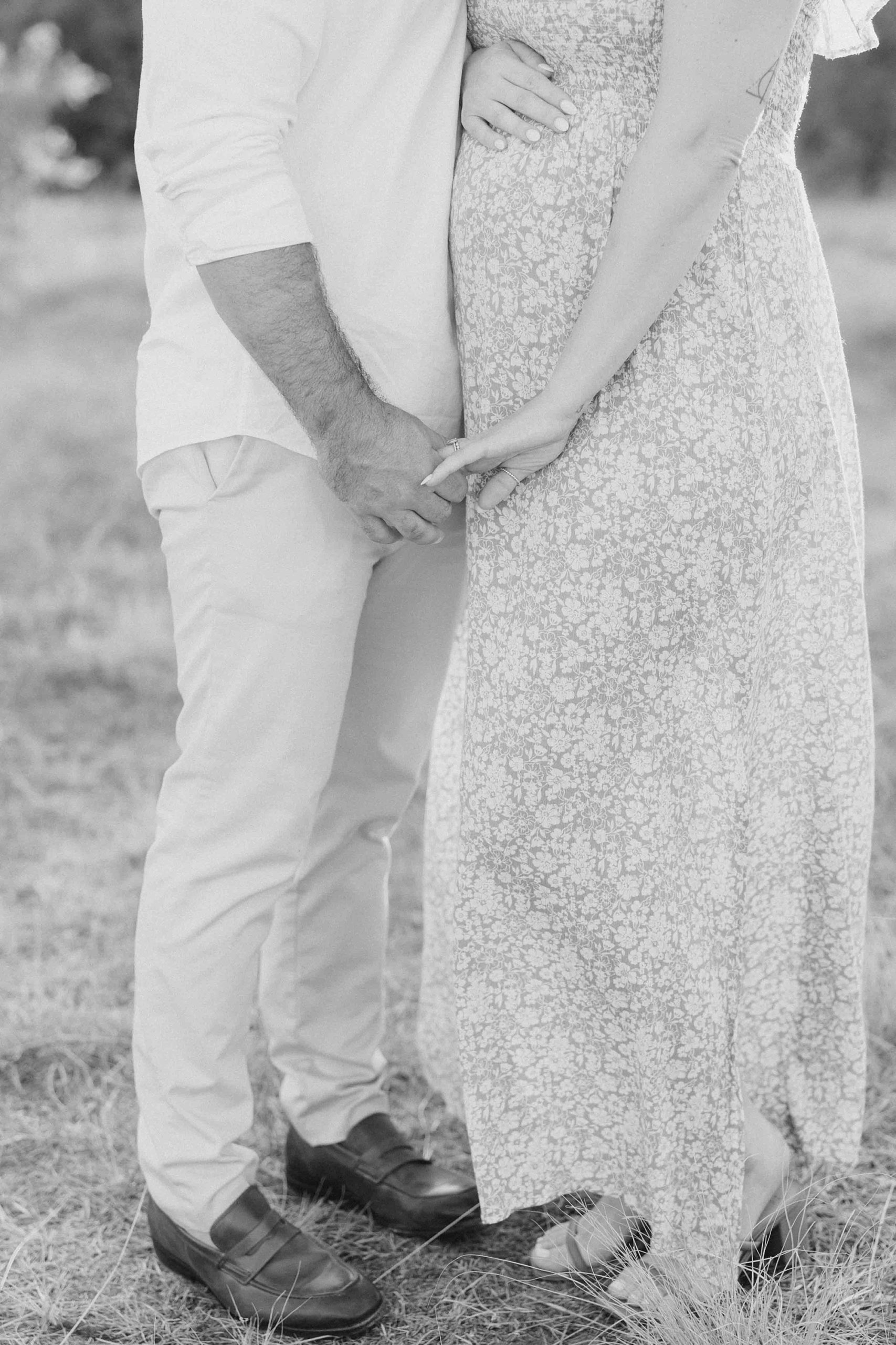 couple holds hands during summer Murrell Park maternity session