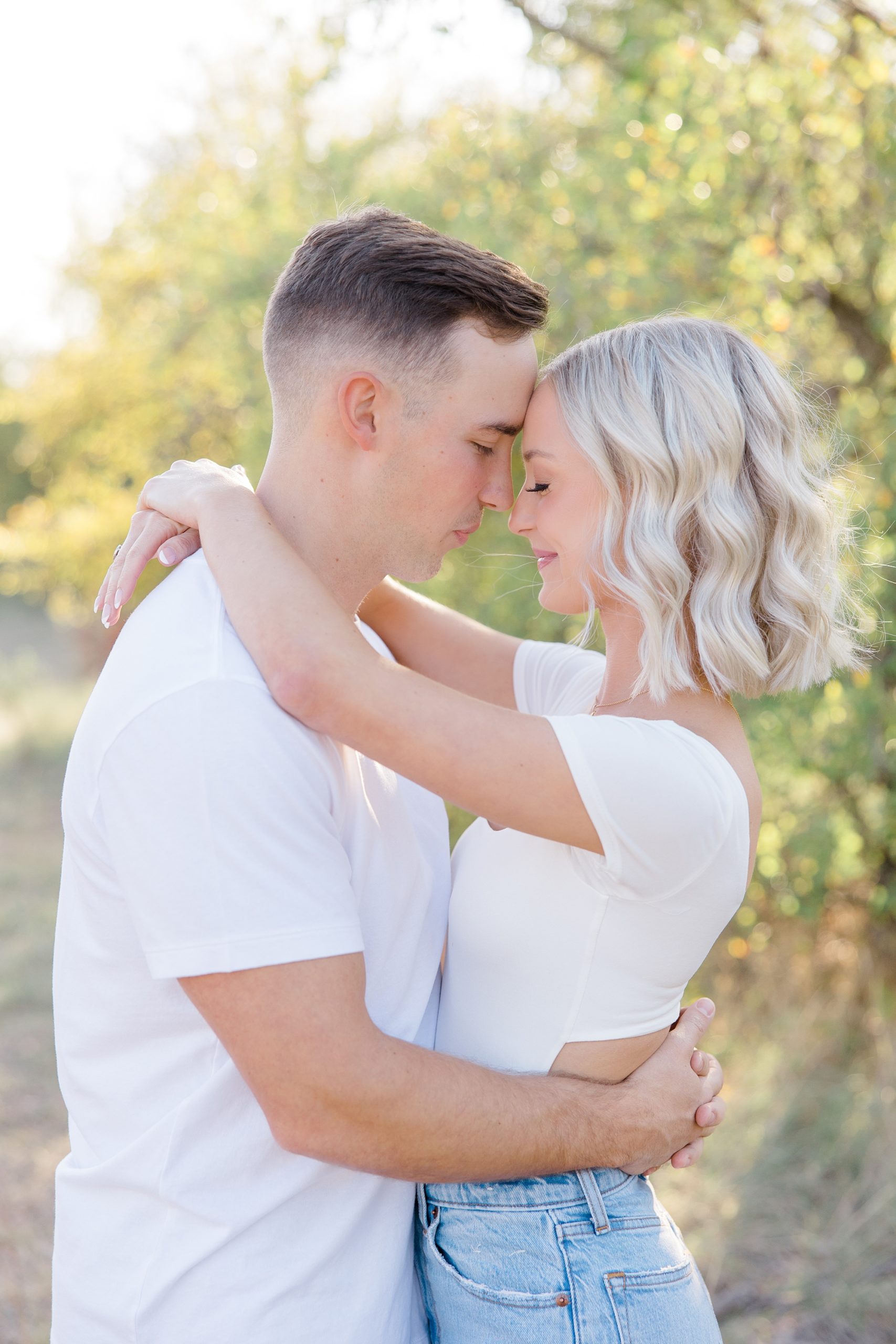 bride and groom hug with foreheads touching during Murrell Park engagement session 