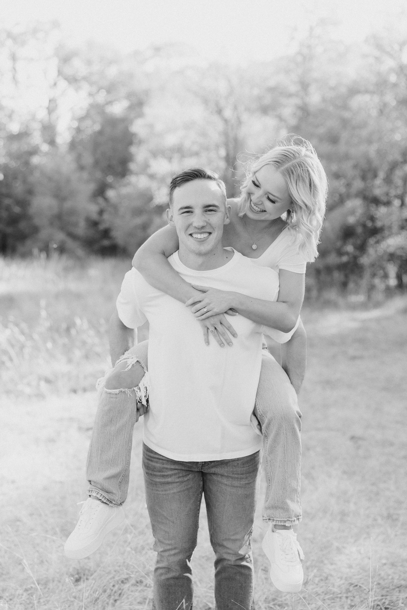 groom carries bride on his back during portraits in Murrell Park