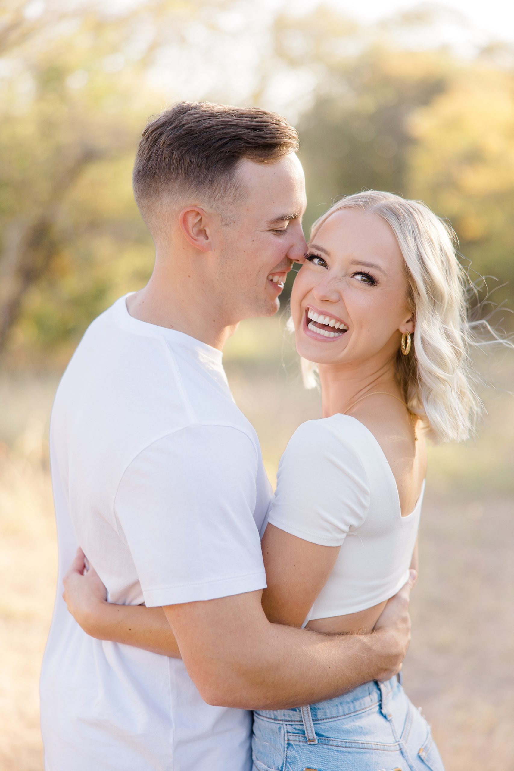 groom nuzzles bride's cheek during TX engagement session 