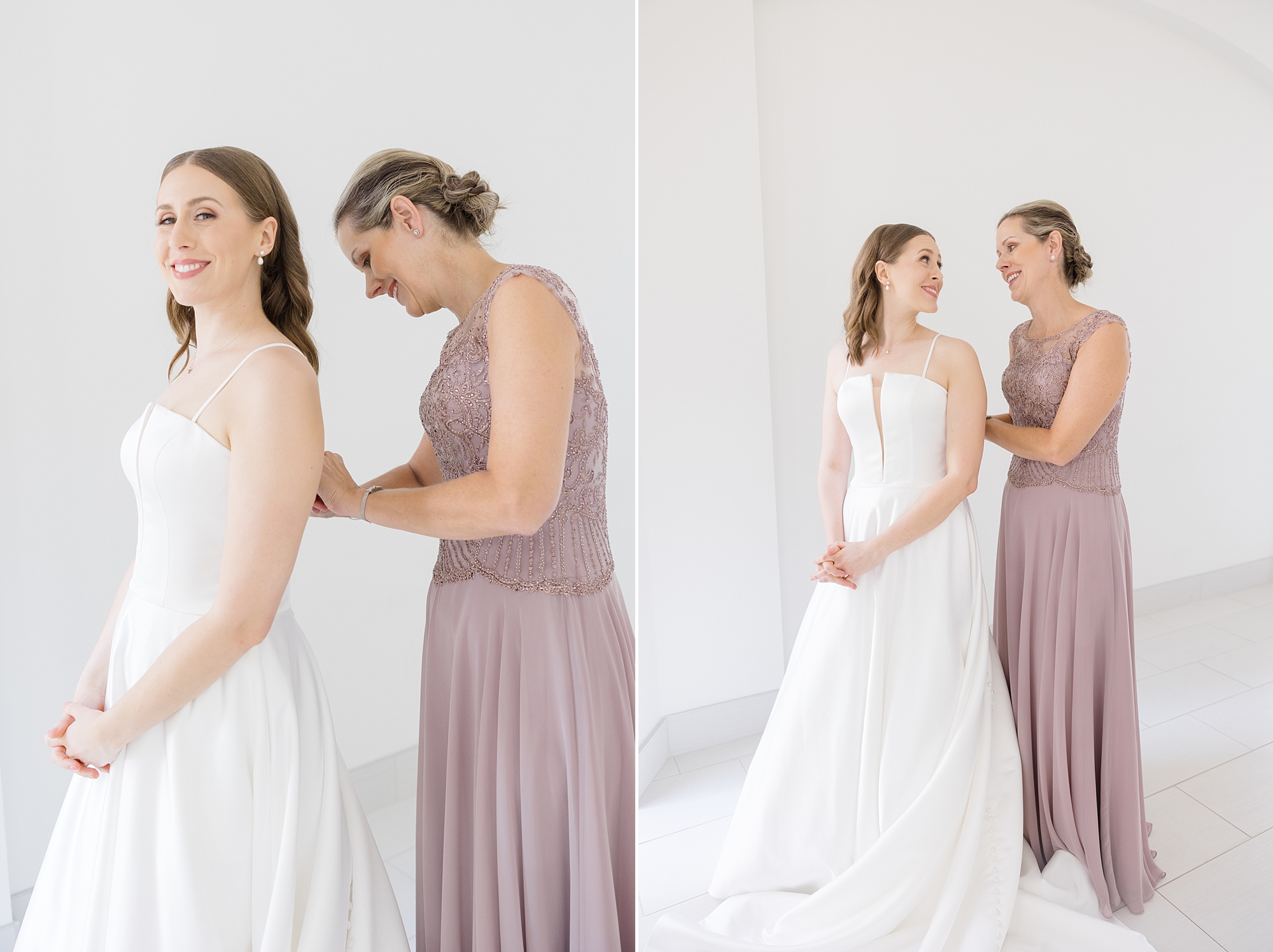 bridesmaid in pink gown helps bride with wedding dress 
